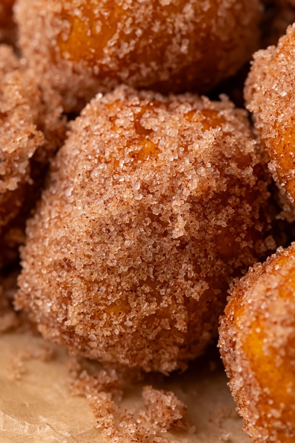 close up of a cinnamon sugar coated Pumpkin Pie Donut Holes stacked on top of one another