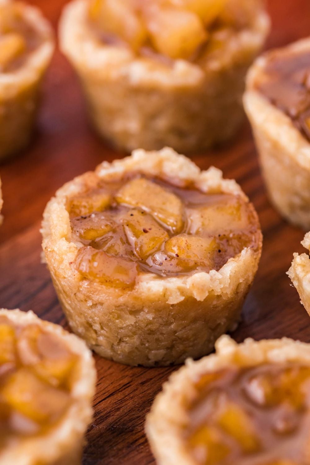 Mini Apple Crisp Bites placed close by one another on table in perfect cup shapes