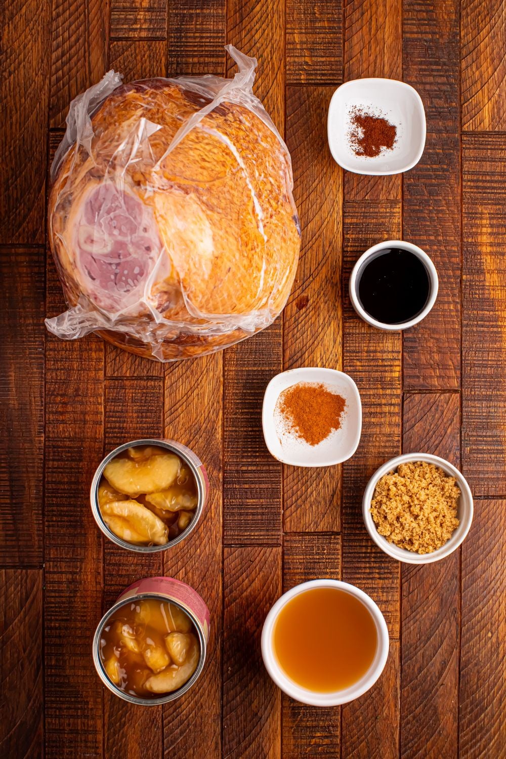 all the ingredients for apple glazed crockpot ham on a wooden table