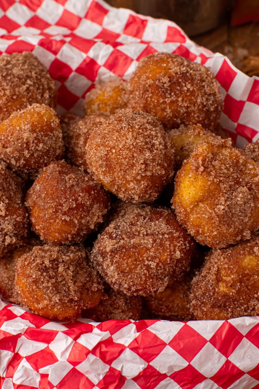 close up of Apple Pie Donut Holes in a red checkered basket