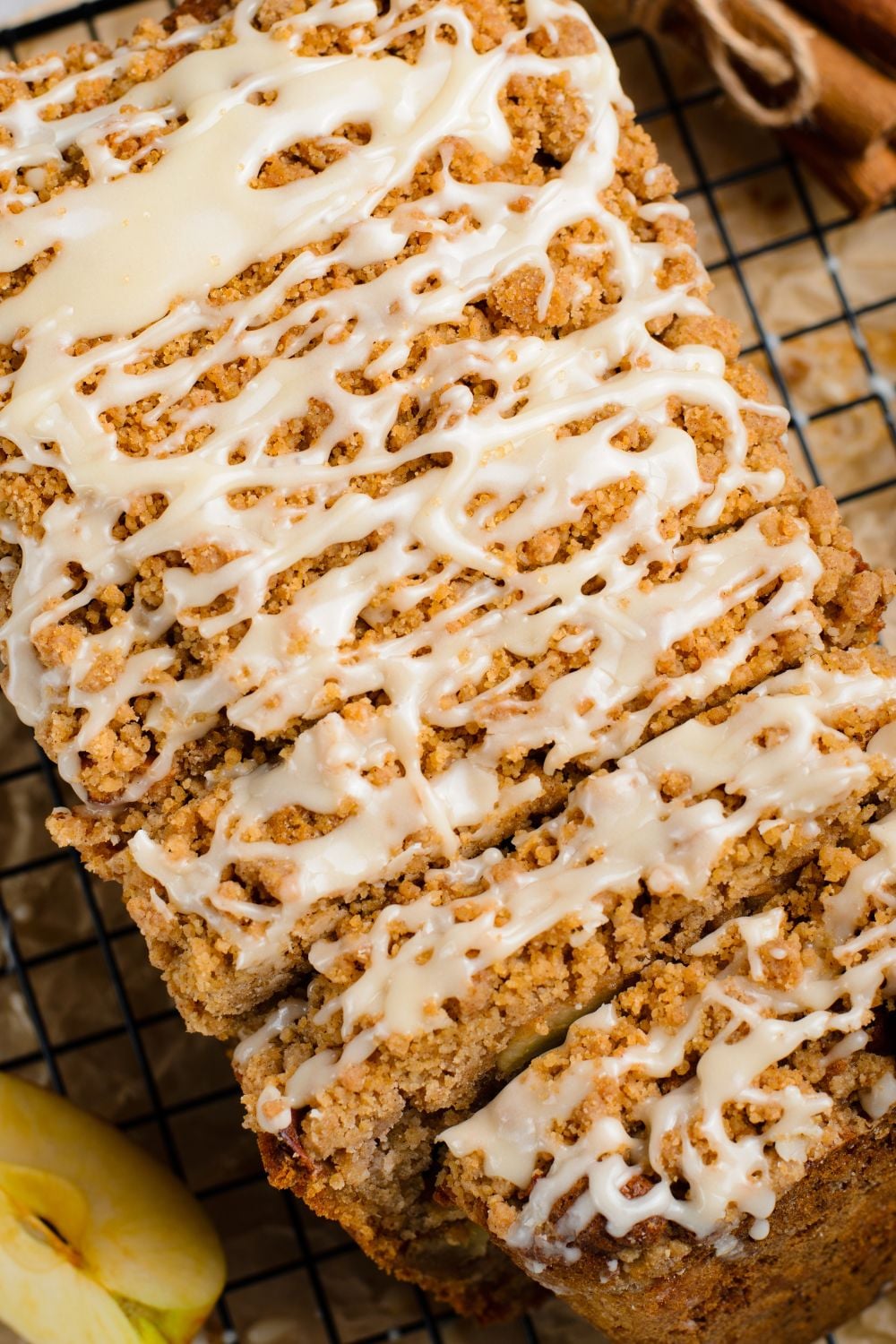 close up view of a Apple Cinnamon Loaf Cake on table with part of the loaf sliced into thick pieces