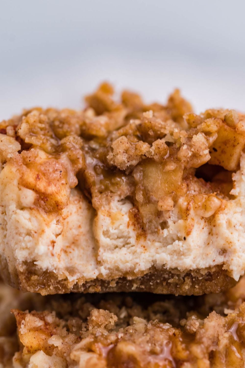 close up of Apple Crisp Cheesecake Bite with part of a bite taken out of it