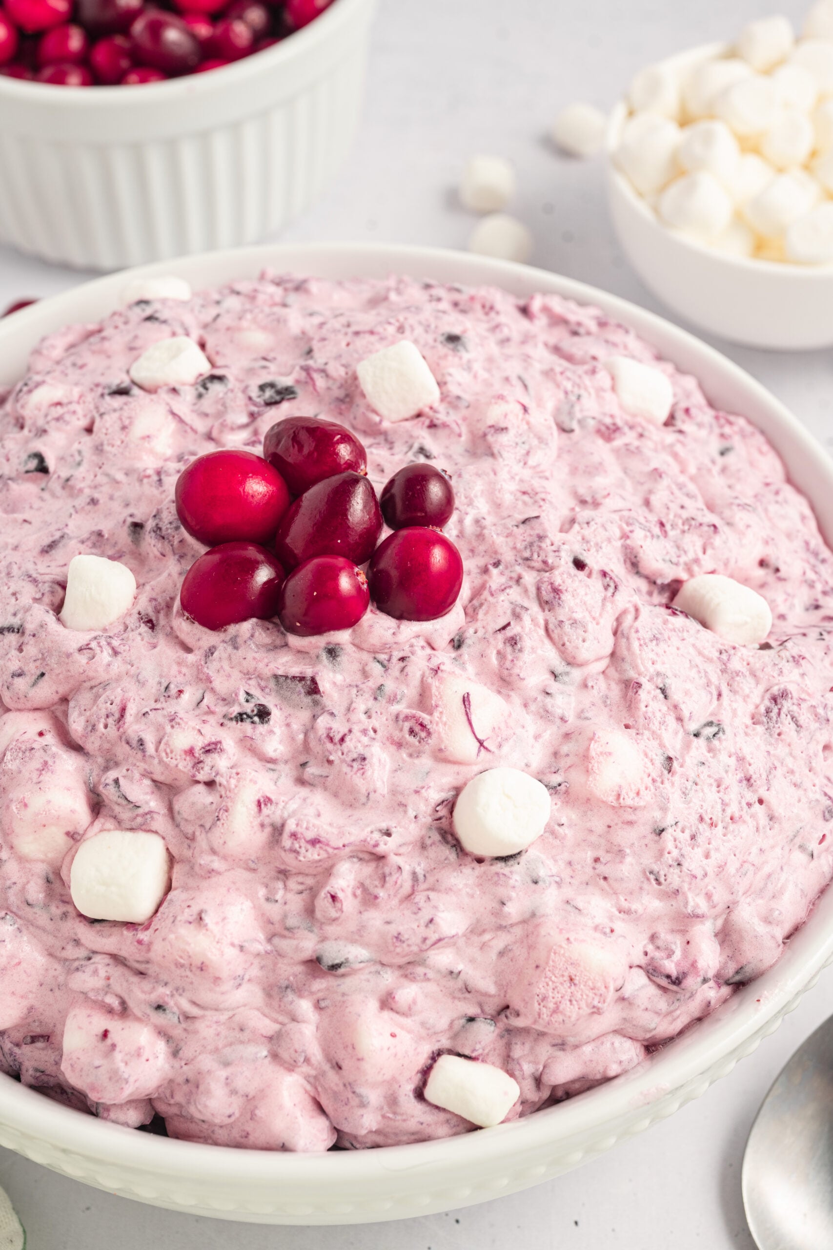 Cranberry Fluff Salad in a white bowl with mini marshmallows