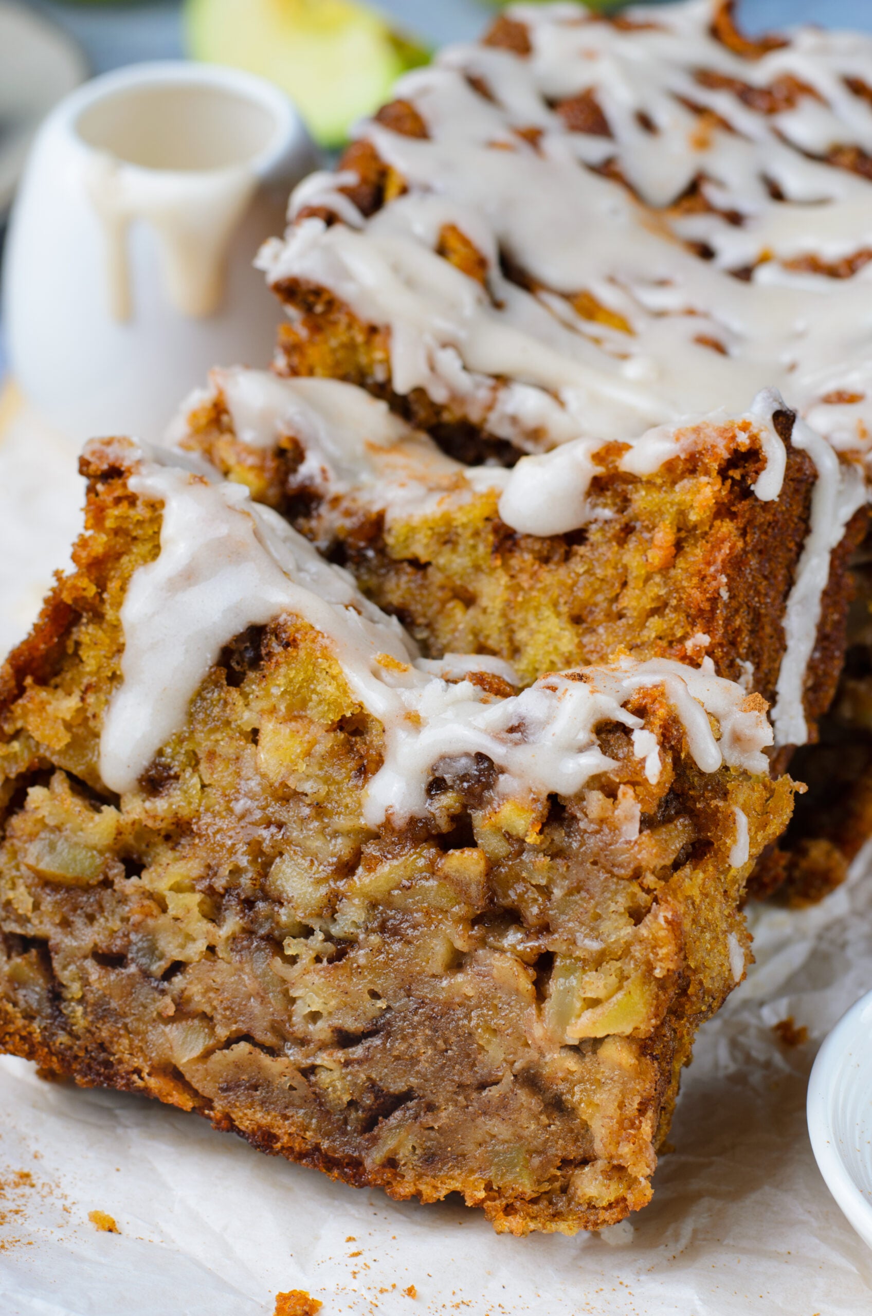 two slices of Amish Apple Fritter Bread up close sliced and covered in glaze
