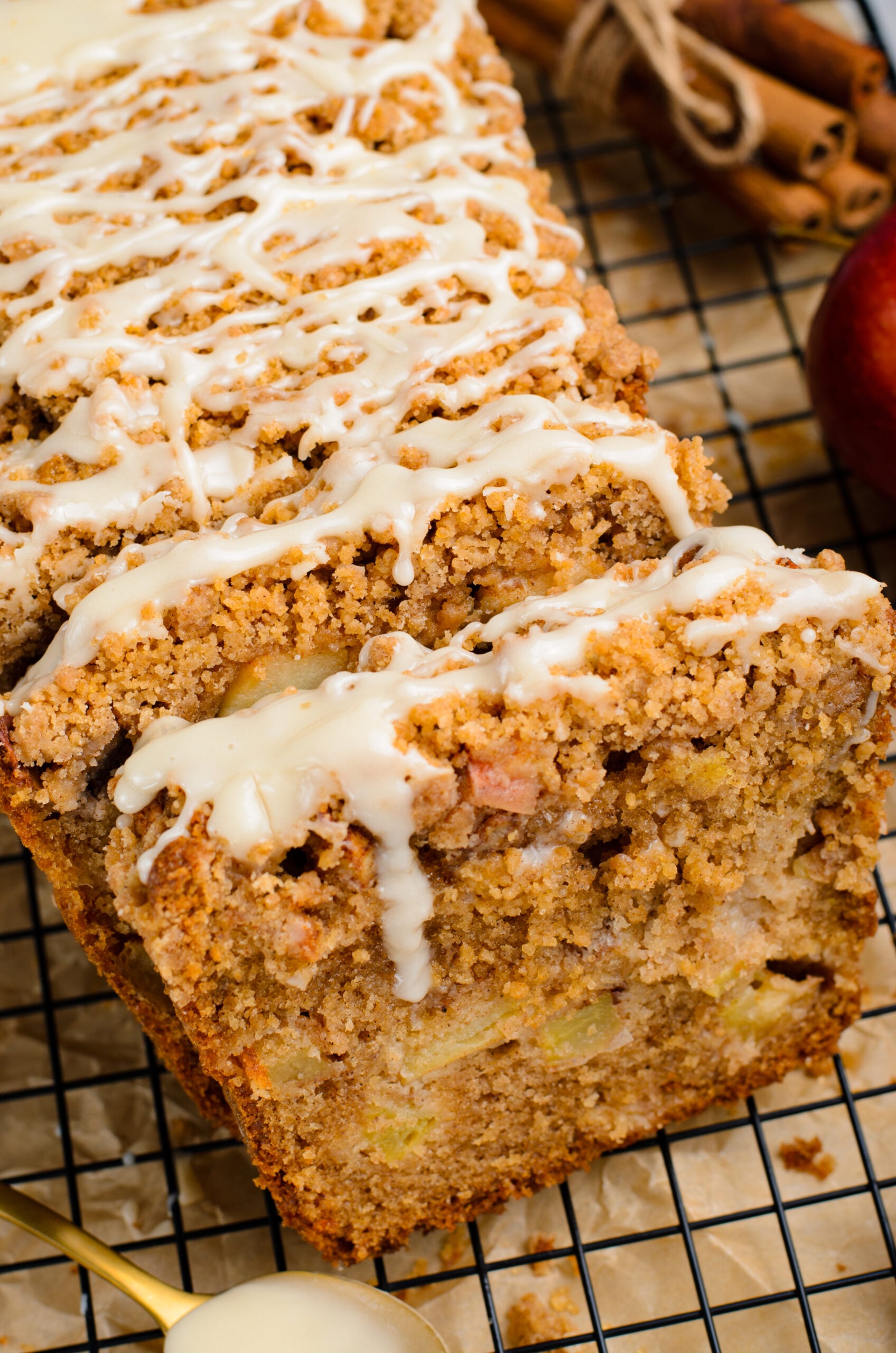 close up view of the entire loaf of the Apple Cinnamon Loaf Cake on a black cooling rack