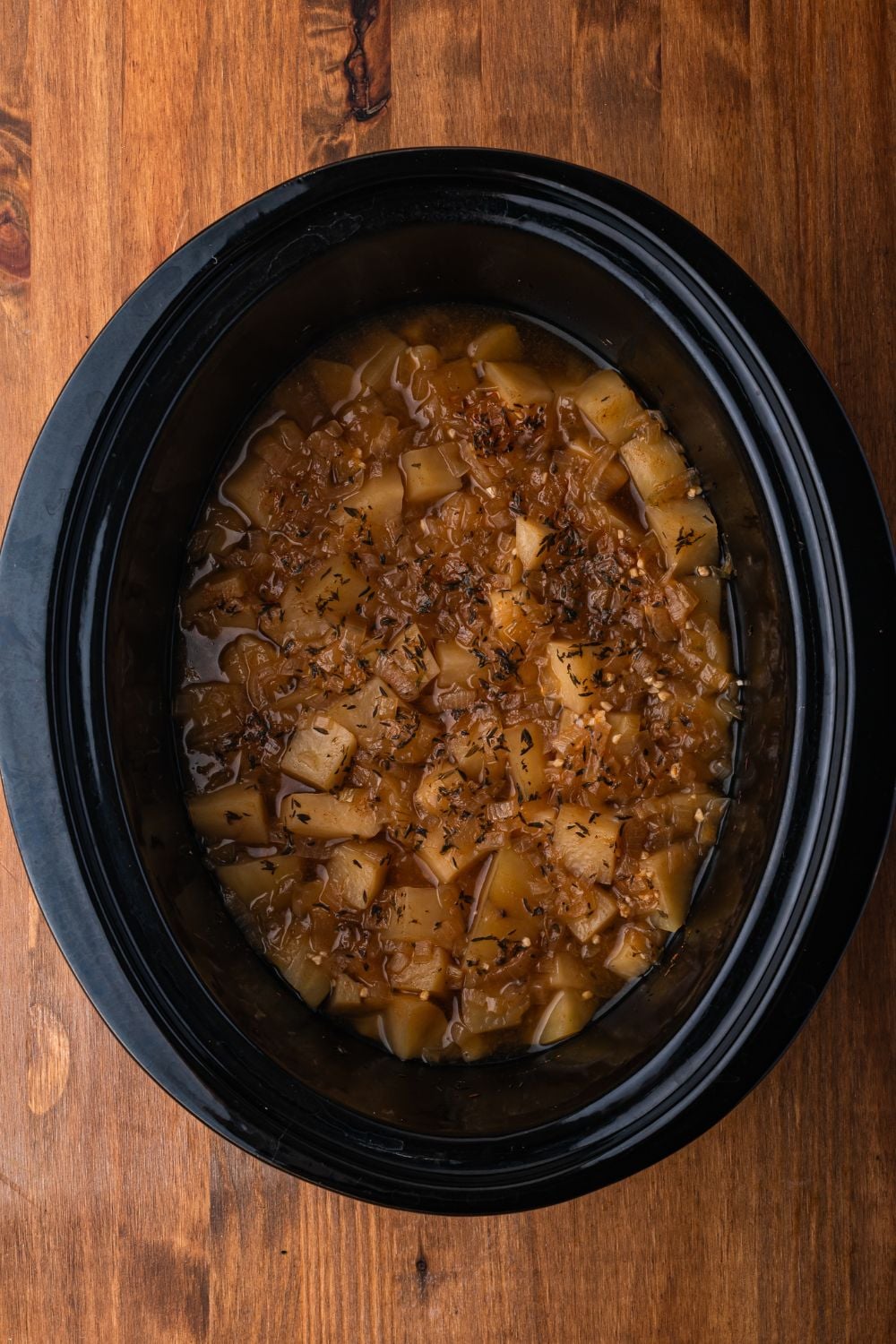 black crockpot with cooked Crockpot Loaded Baked Potato Soup