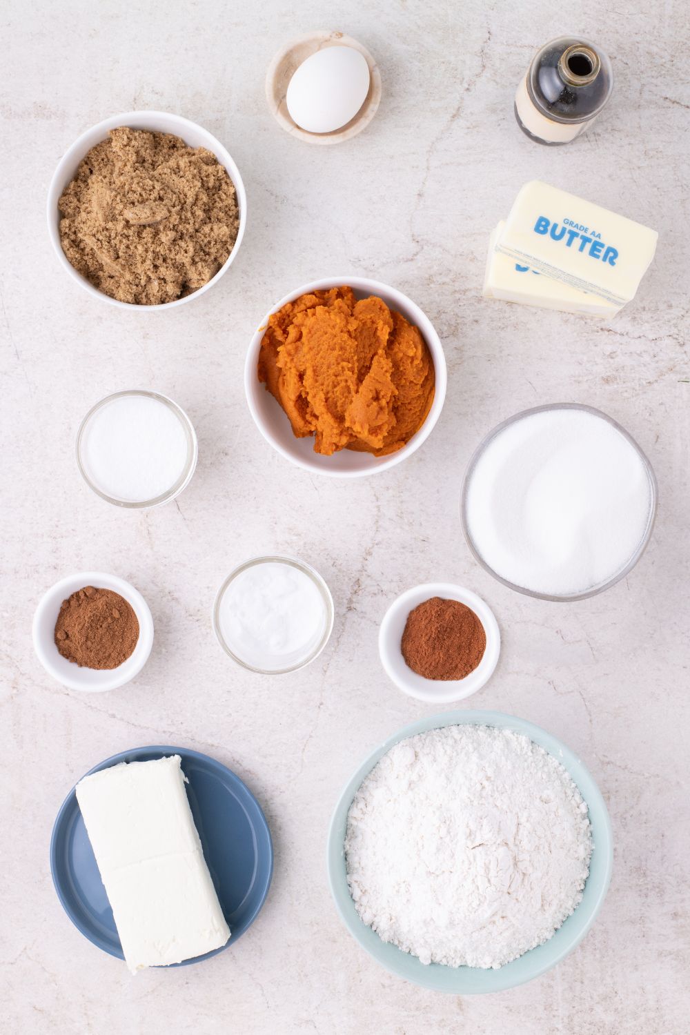 all the ingredients for Pumpkin Cheesecake Cookies on table in single serve bowls