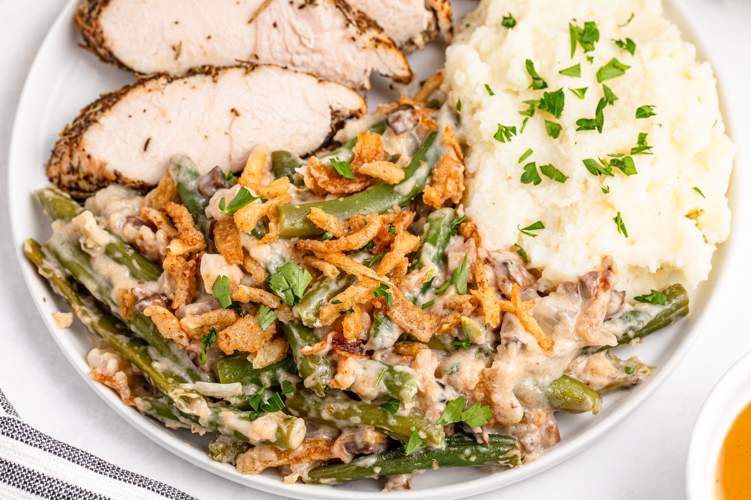 overhead shot of a plate of the Best Ever Green Bean Casserole with turkey and mashed potatoes