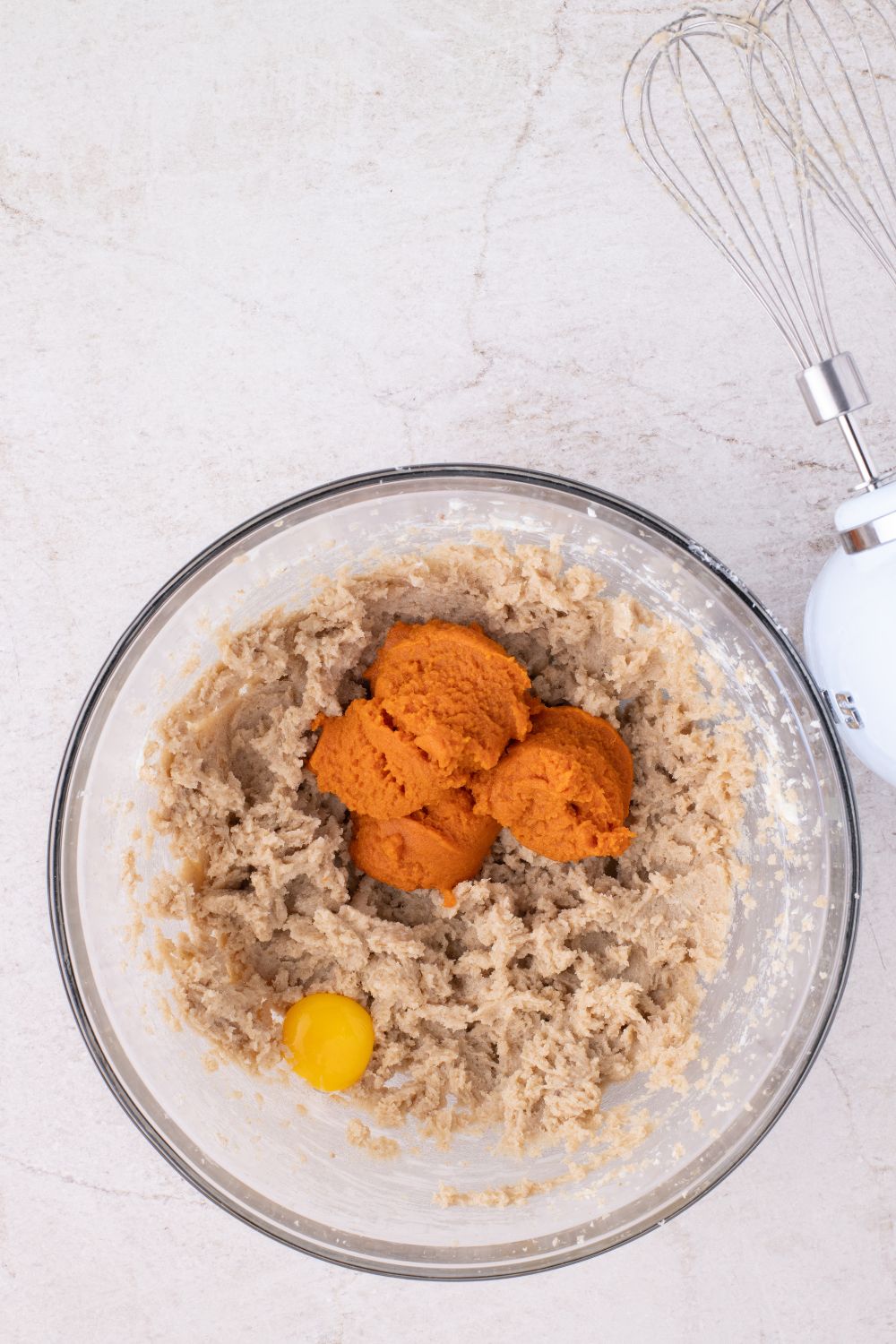glass bowl of raw pumpkin batter in bowl for making pumpkin cookies
