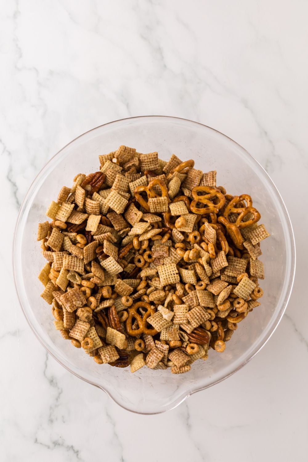 Pumpkin Spice Chex Mix in a glass bowl on table for preparing it