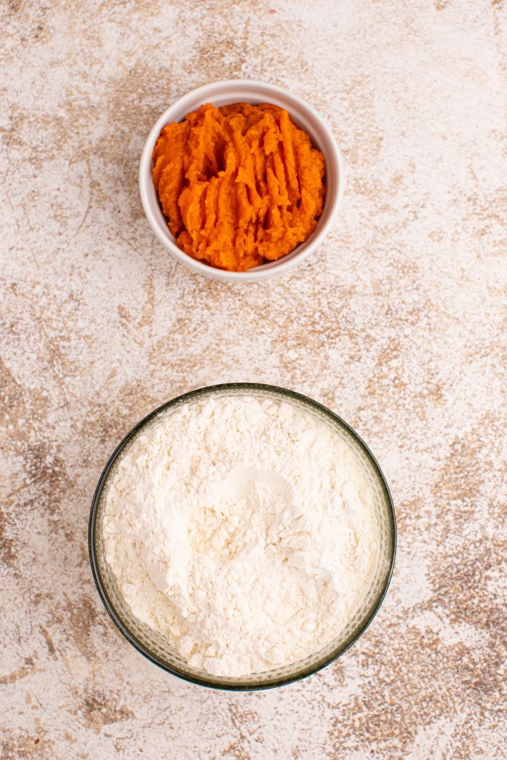 pumpkin puree and self rising flour in glass containers on table 