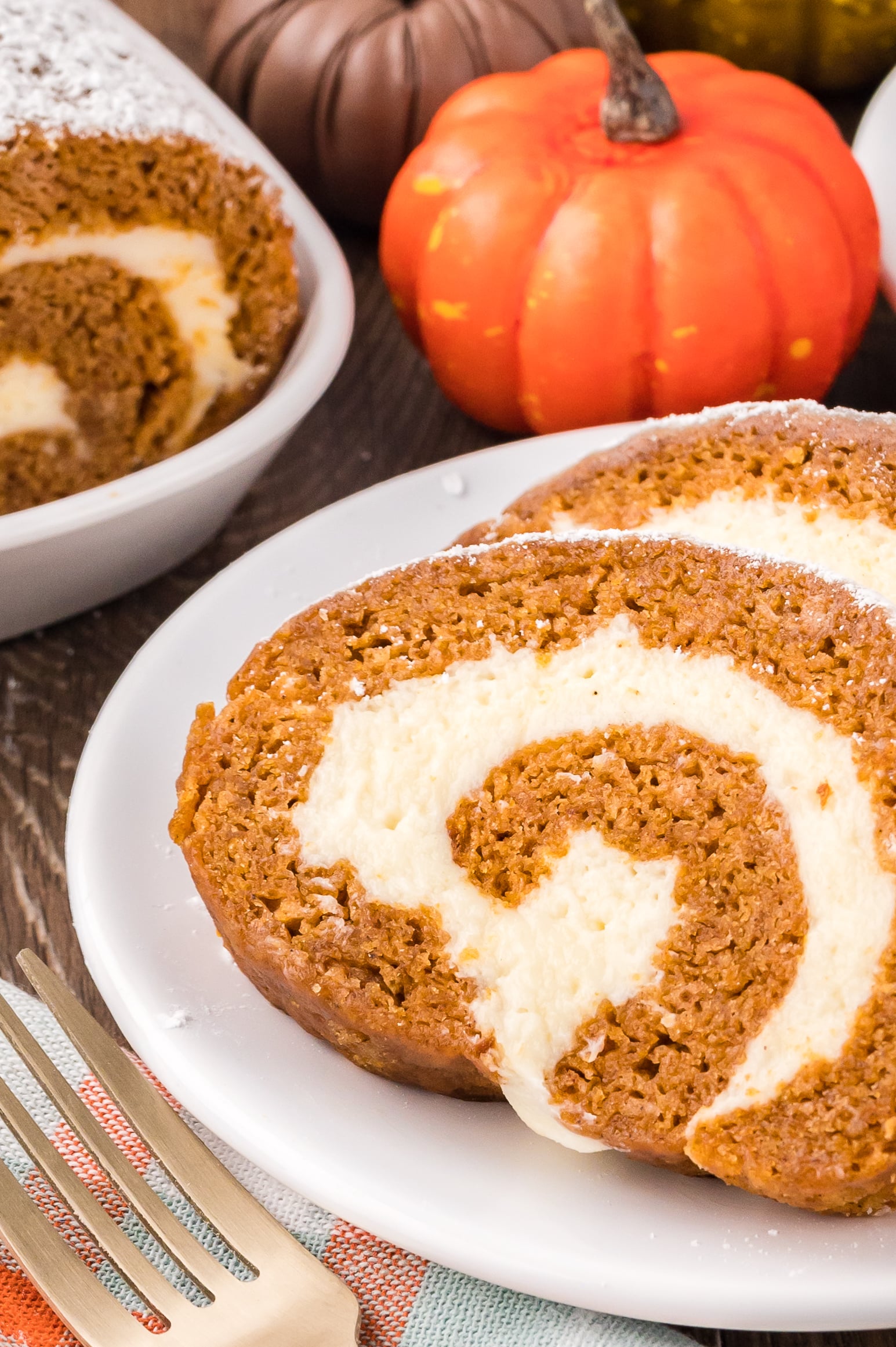 Slices of the Pumpkin Cake Roll on a white plate