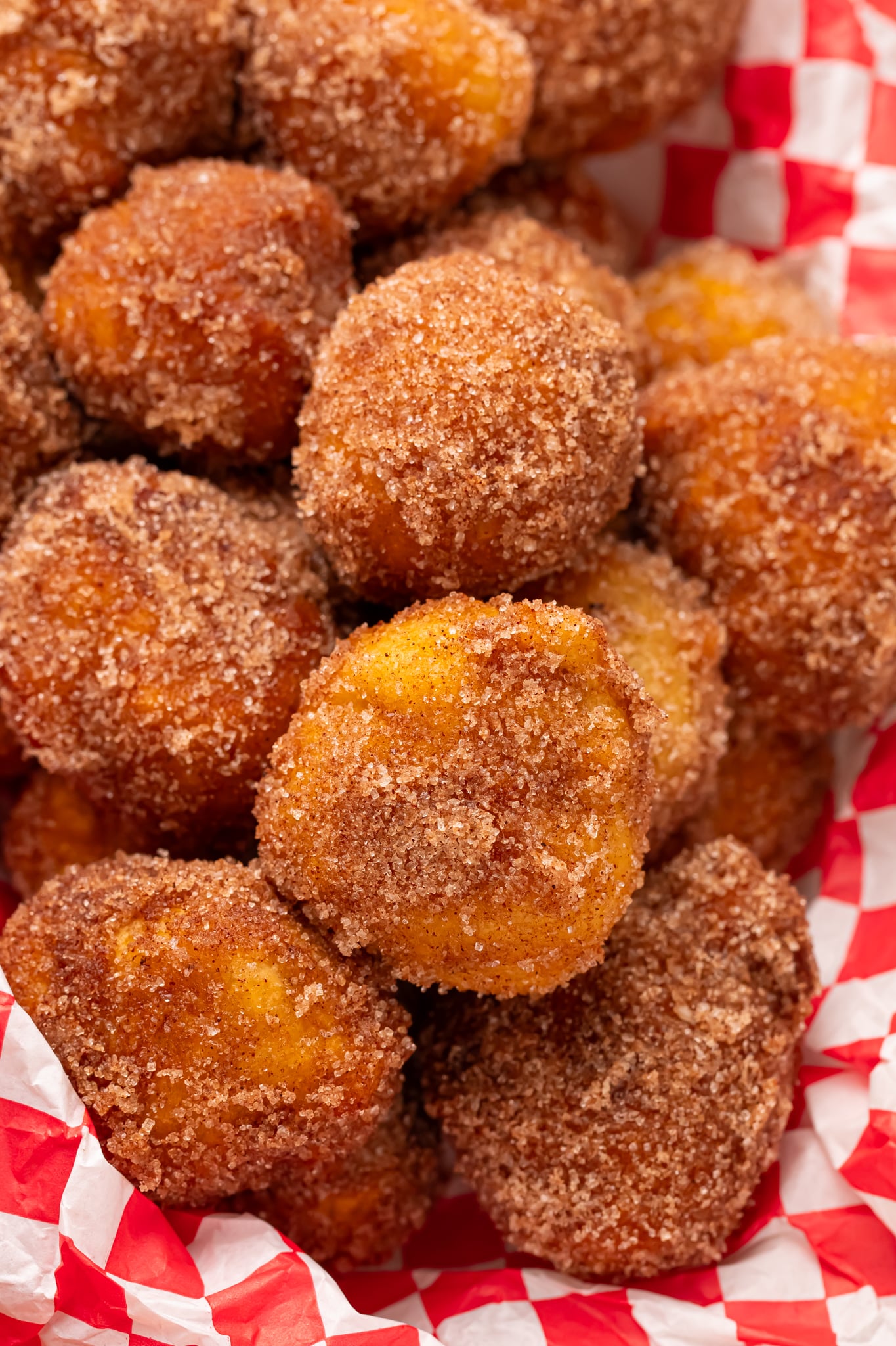 Apple Pie Donut Holes in a basket with a checked parchment paper in basket