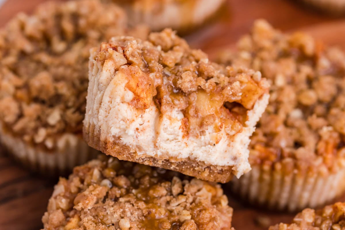 close up of the Apple Crisp Cheesecakes with a bite missing from the top one