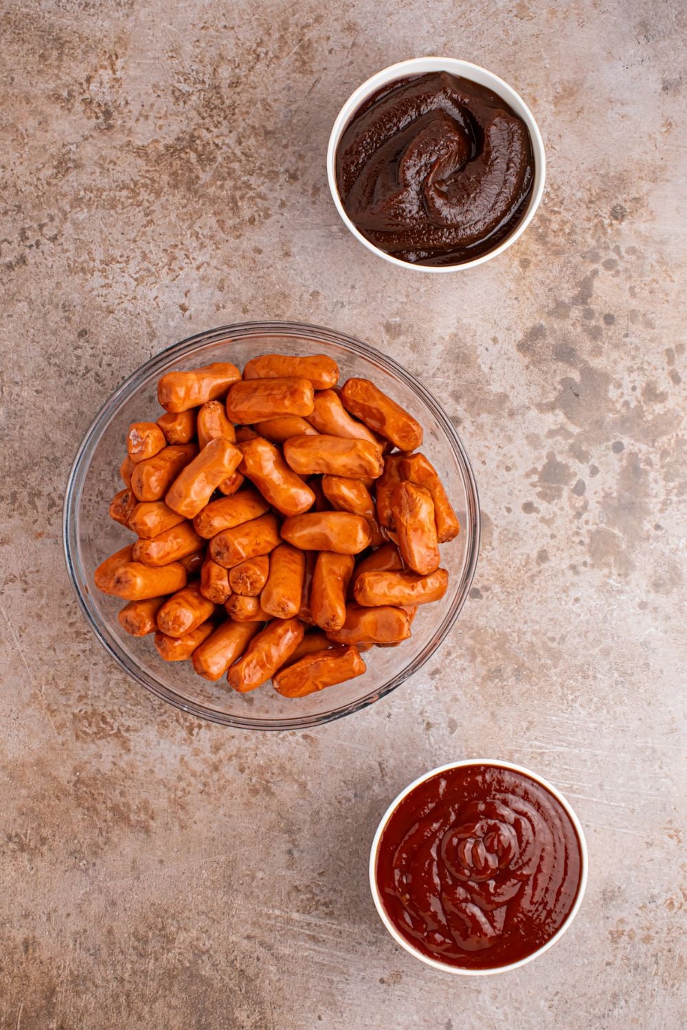 glass bowls with bbq sauce, apple butter, and lil smokies 
