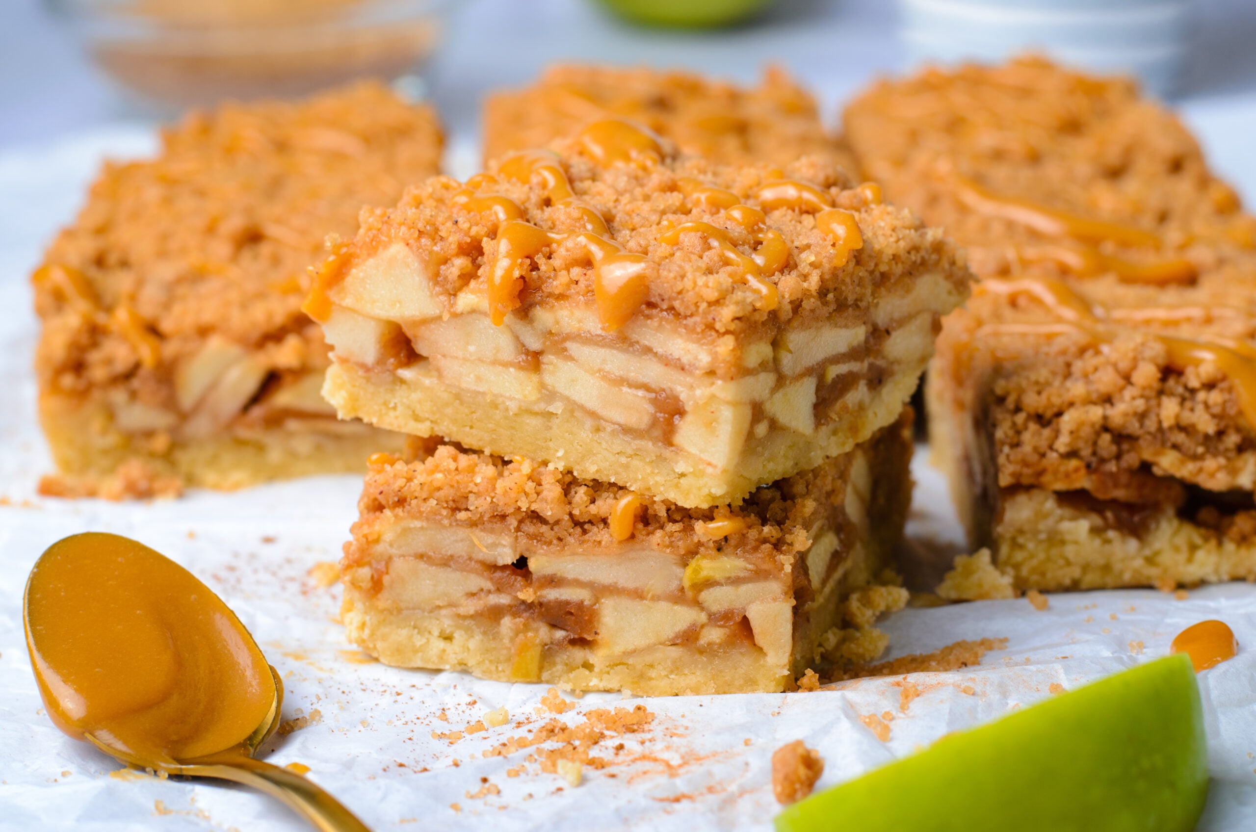 Caramel Apple Pie Bars cut into squares then stacked on top of each other