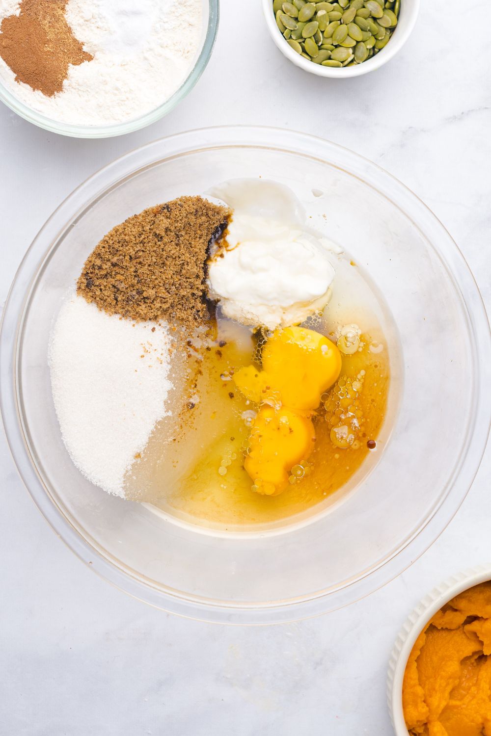 wet ingredients for making homemade Starbucks Pumpkin Bread in a glass bowl on table