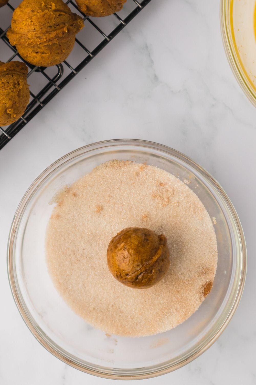 Pumpkin Spice Donut Hole in a glass bowl with cinnamon sugar mixture 