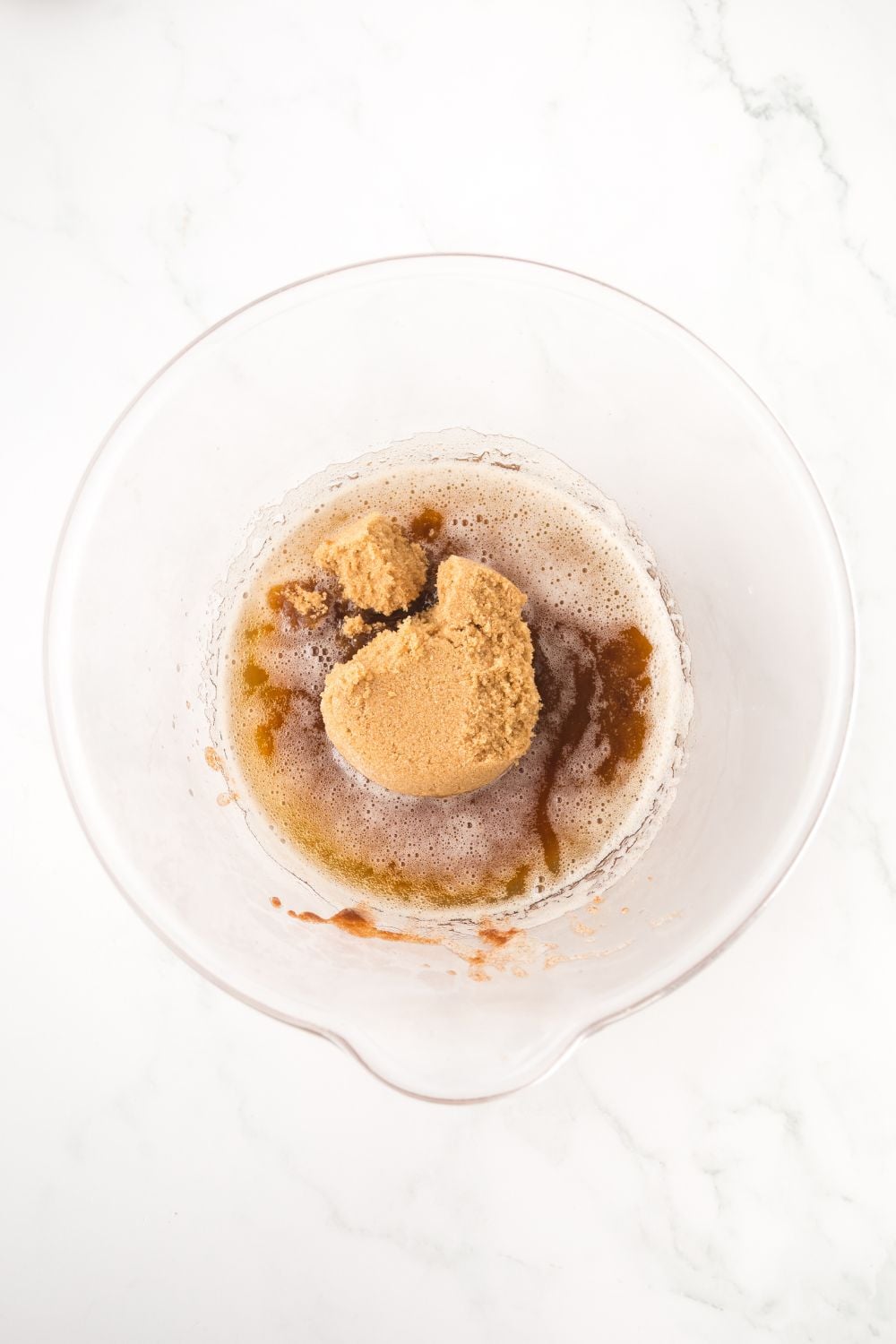 ingredients to make brown butter in a glass bowl on a white table