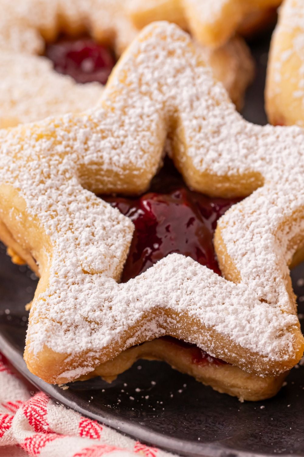 close up of a star shaped Linzer Cookies on a plate