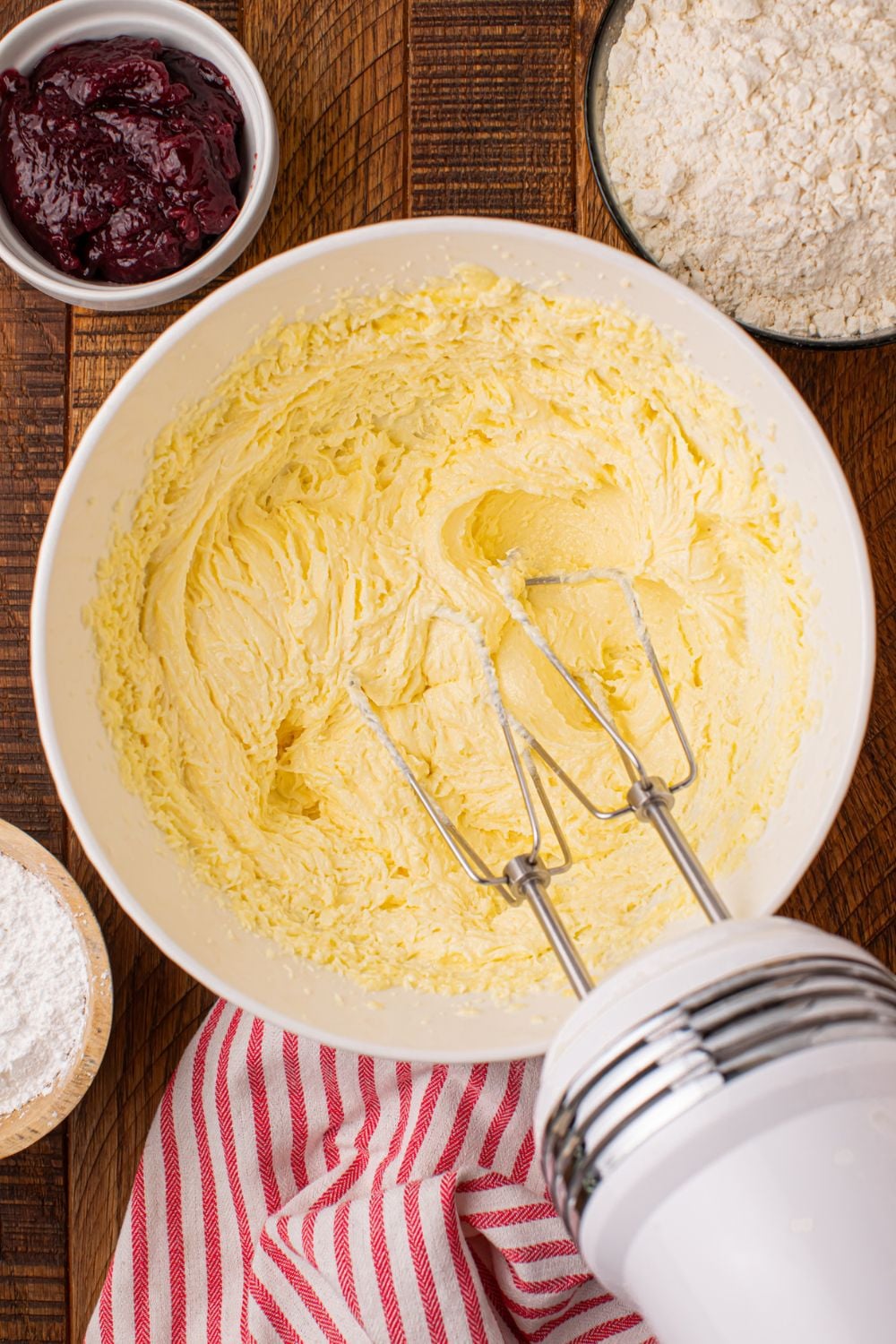 Linzer cookie batter being mixed up with a hand mixer