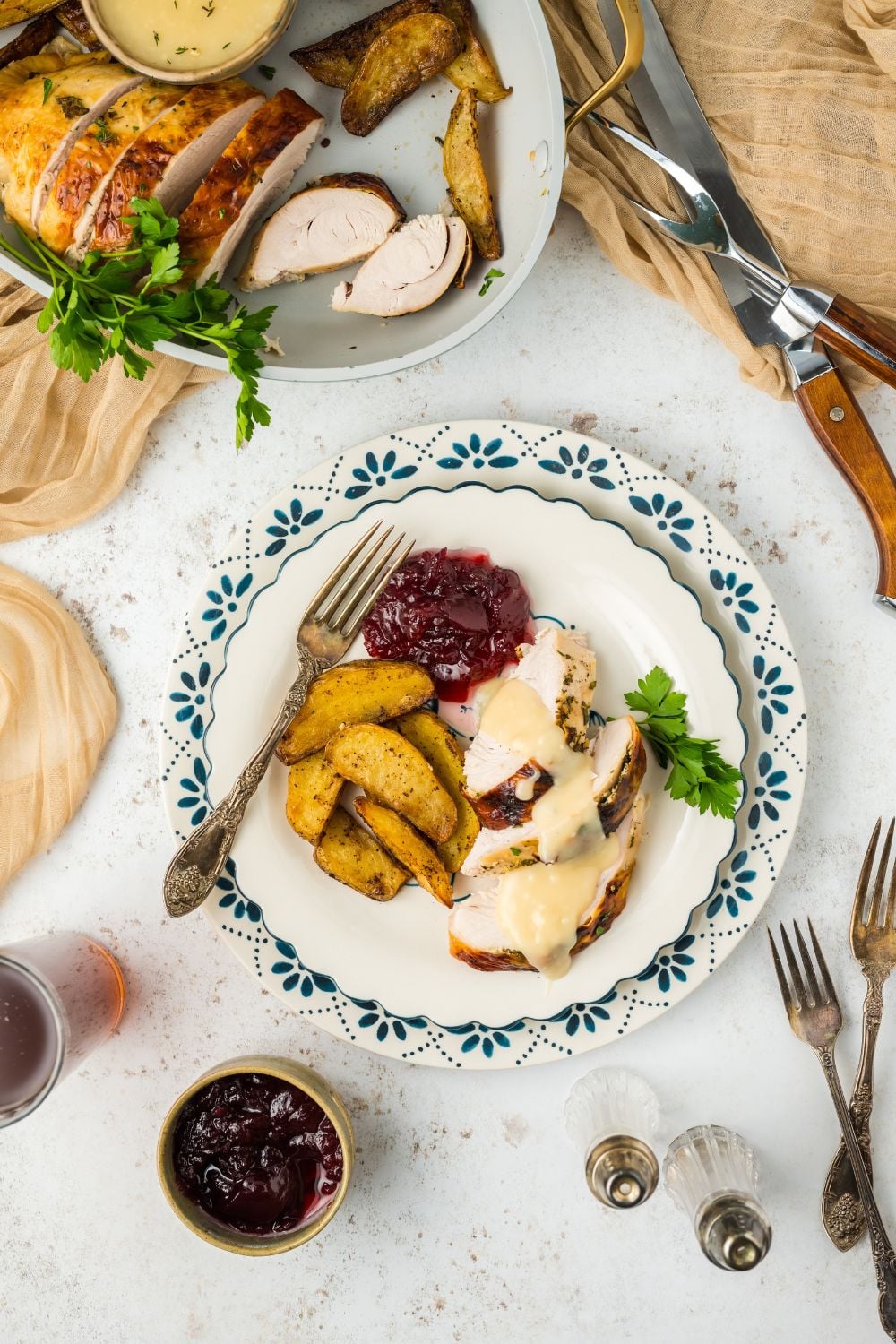 Roasted Turkey Breast on plate on table with other holiday sides
