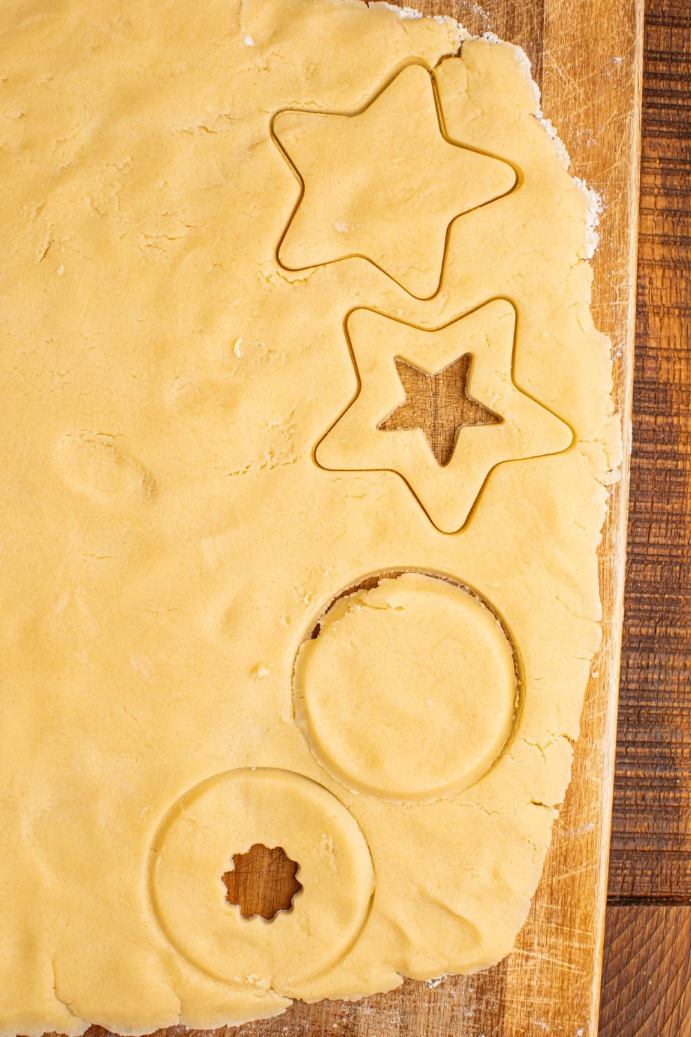 rolled out cookie dough with star and circles cut out