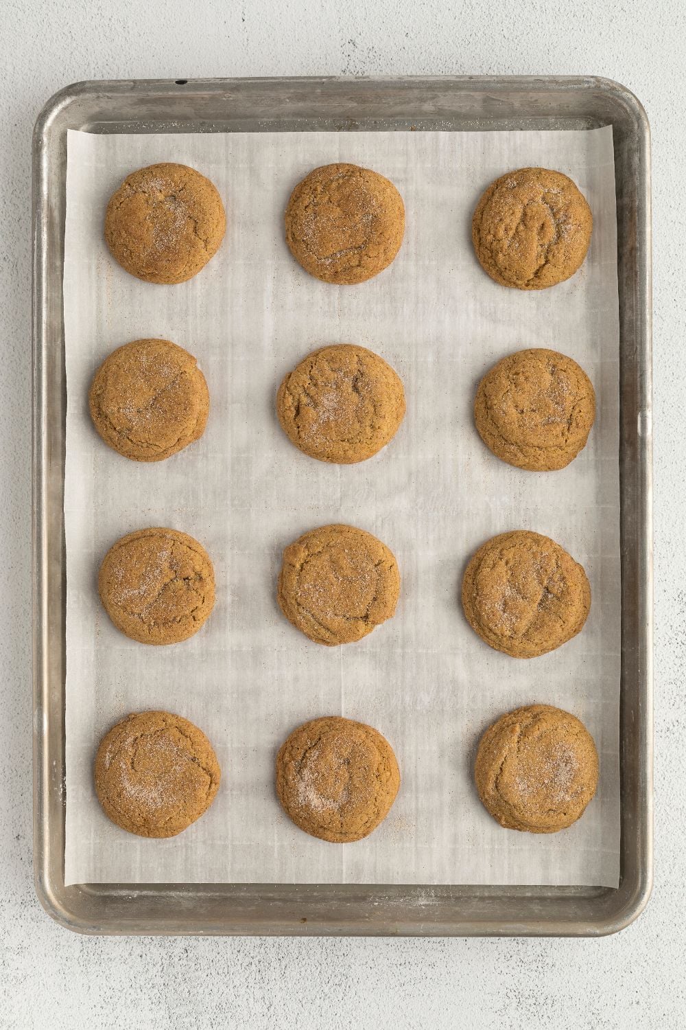 Pumpkin Snickerdoodle Cookies spread out on baking tray 
