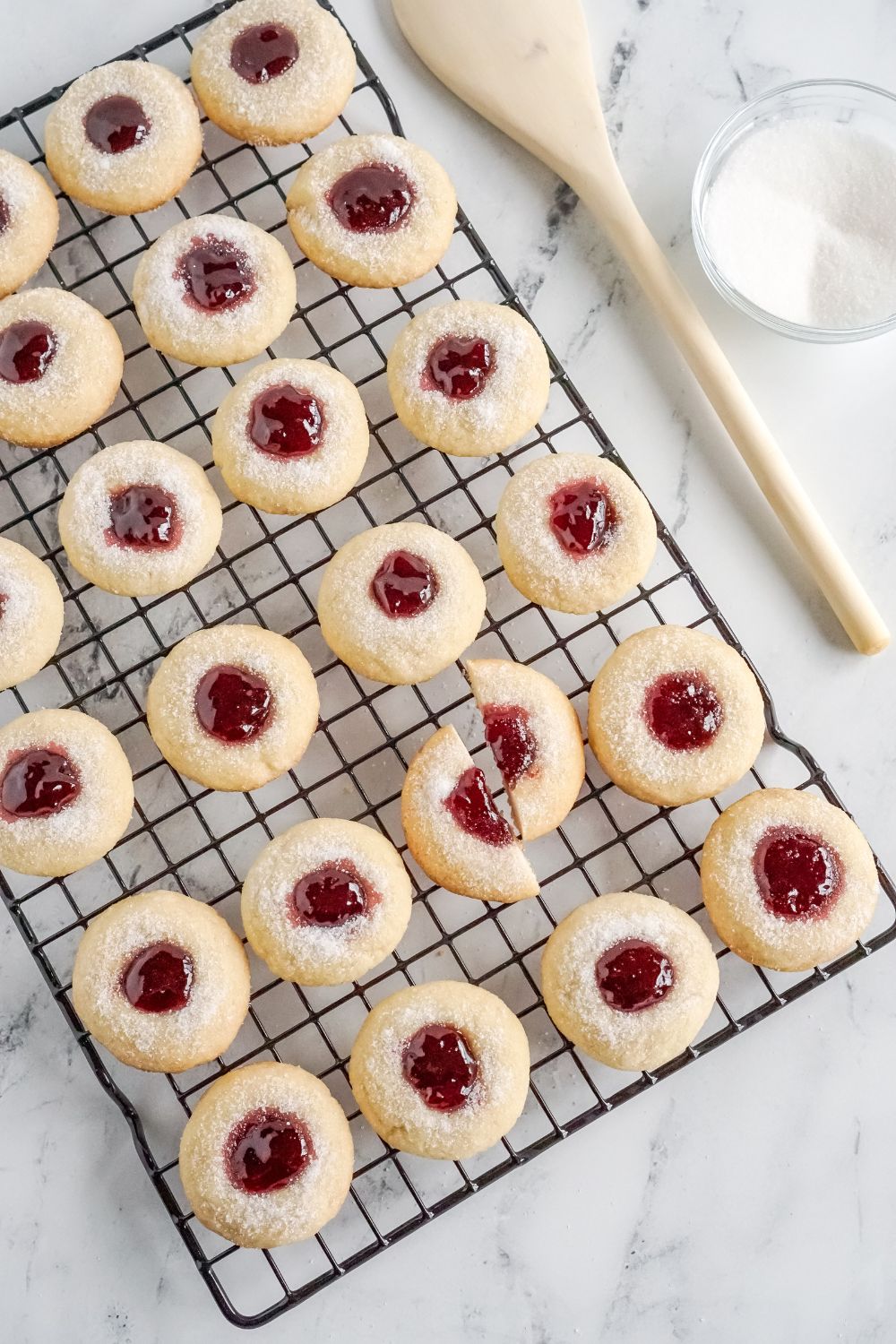 cooling rack with Raspberry Thumbprint Cookies spread out and one cut in half