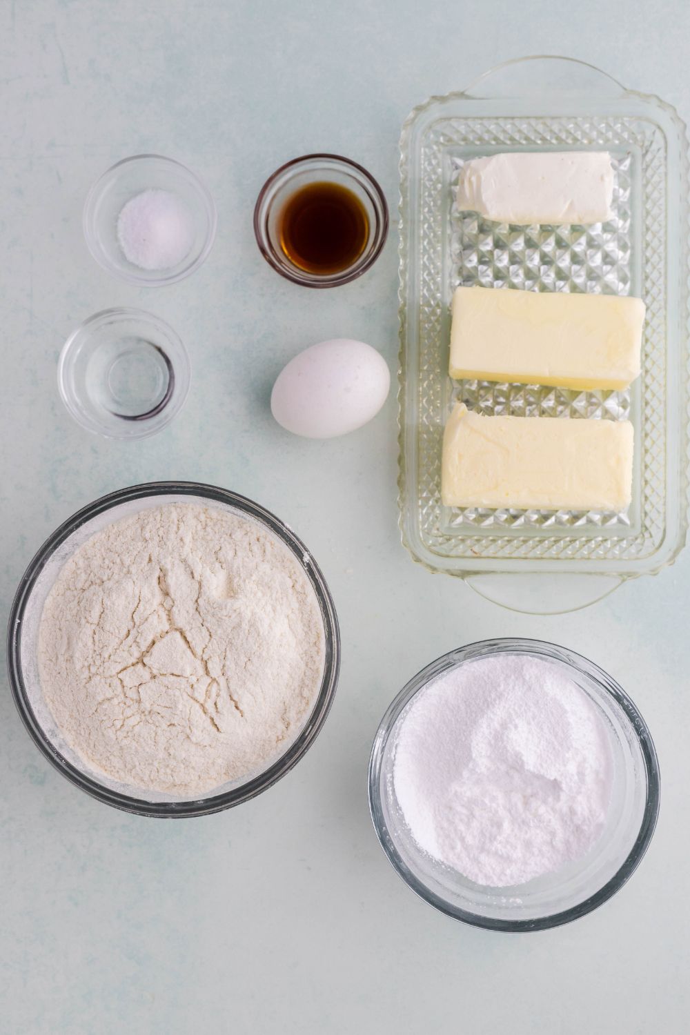 ingredients for classic spritz cookies in single serve bowls on table