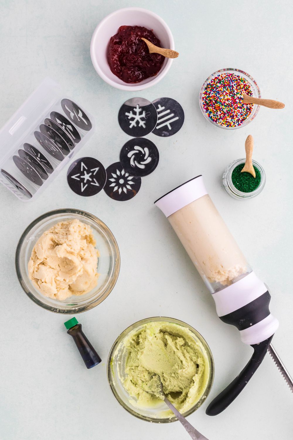 Spritz Christmas Cookies in the machine with the different dips and colored cookie dough