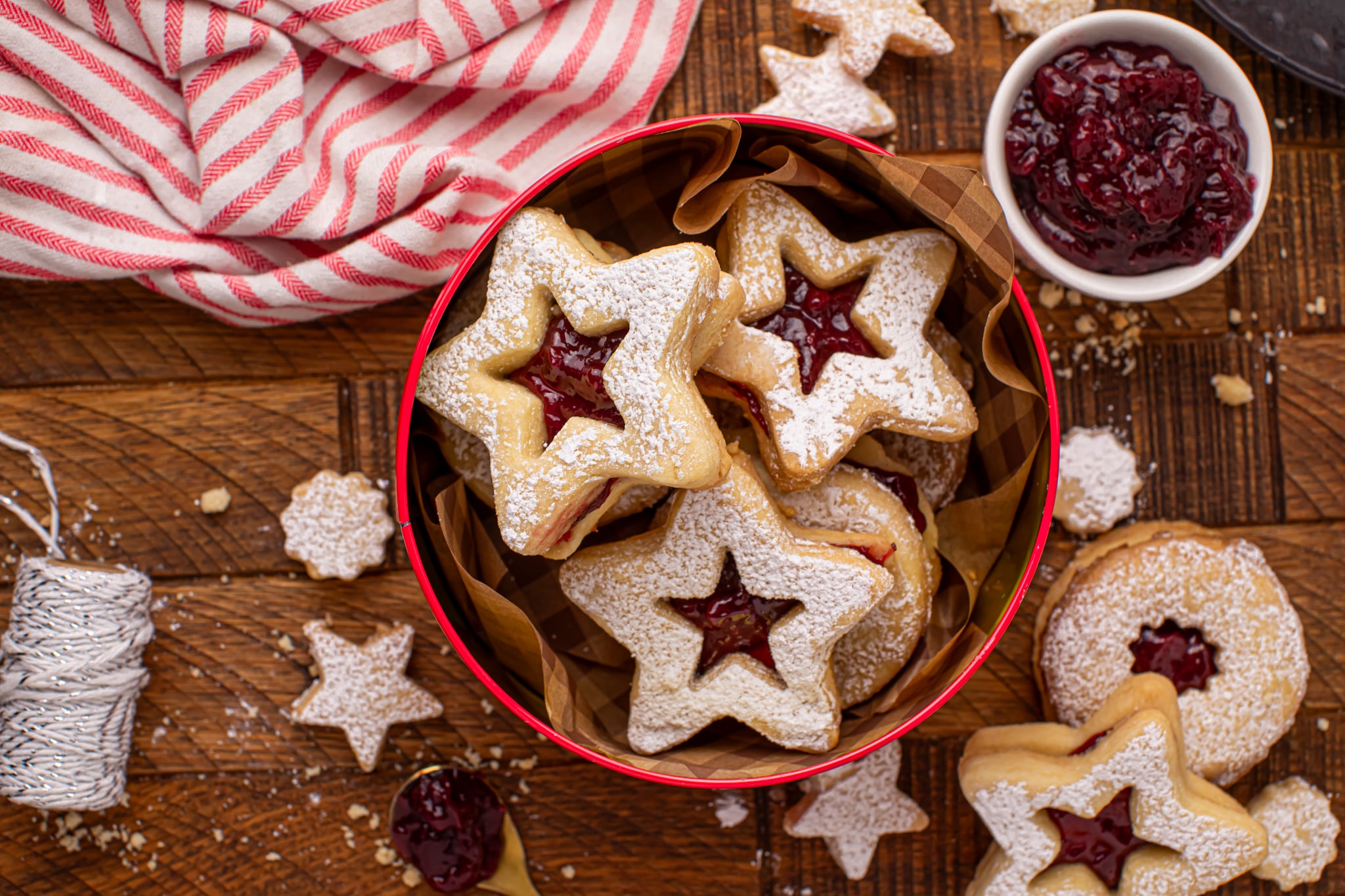 Overhead shot of Easy Linzer Cookies with Jam Filling in a cookie tin