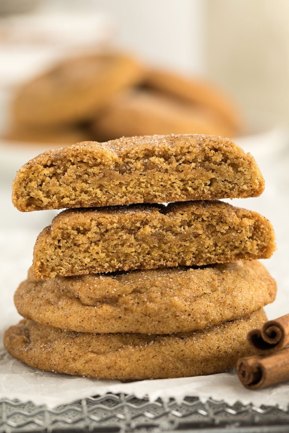stack of cookies with the top two cut in half to show how thick and soft the cookies are 