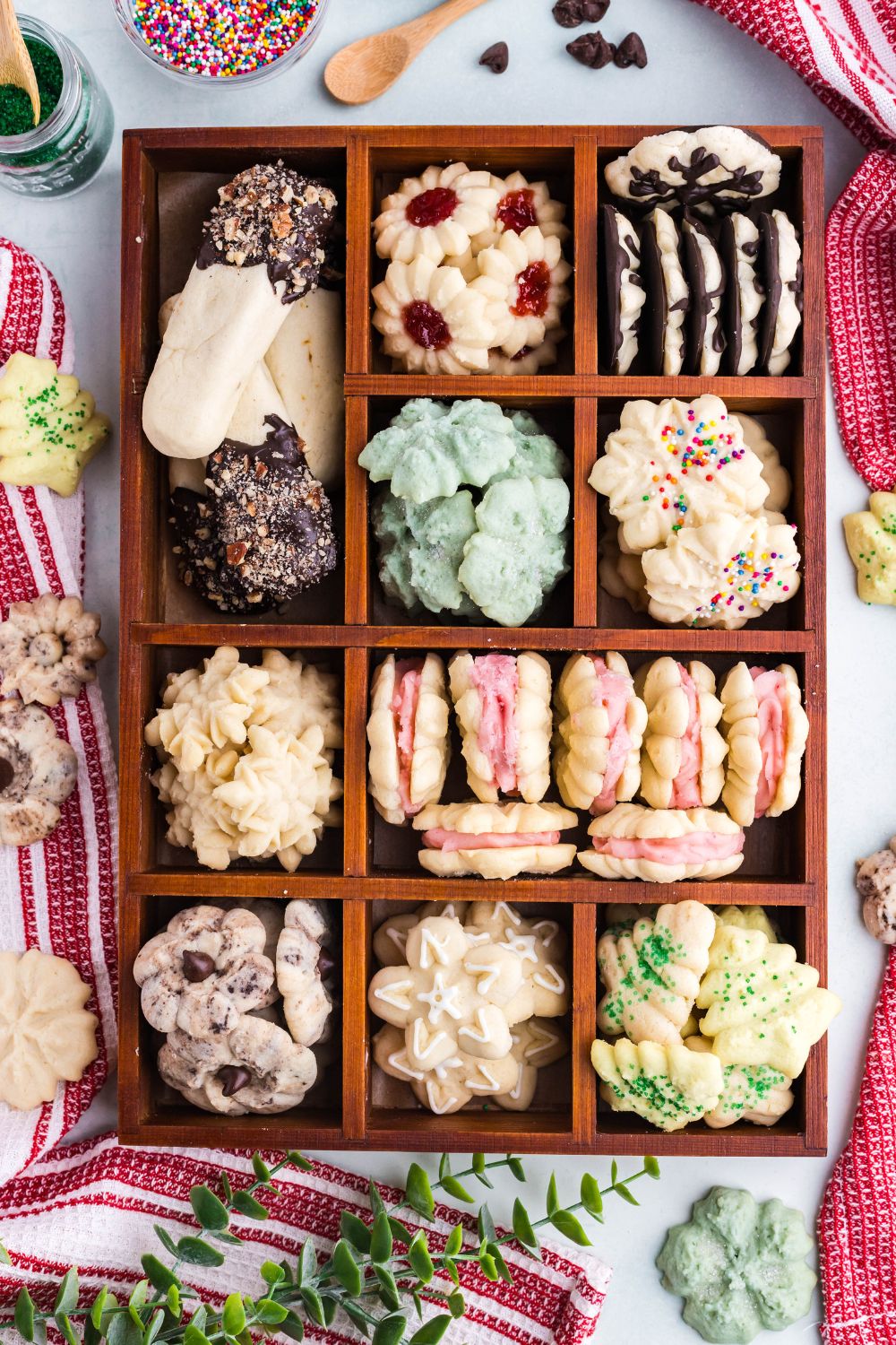 wooden tray with compartments and spritz cookies and greenery on table