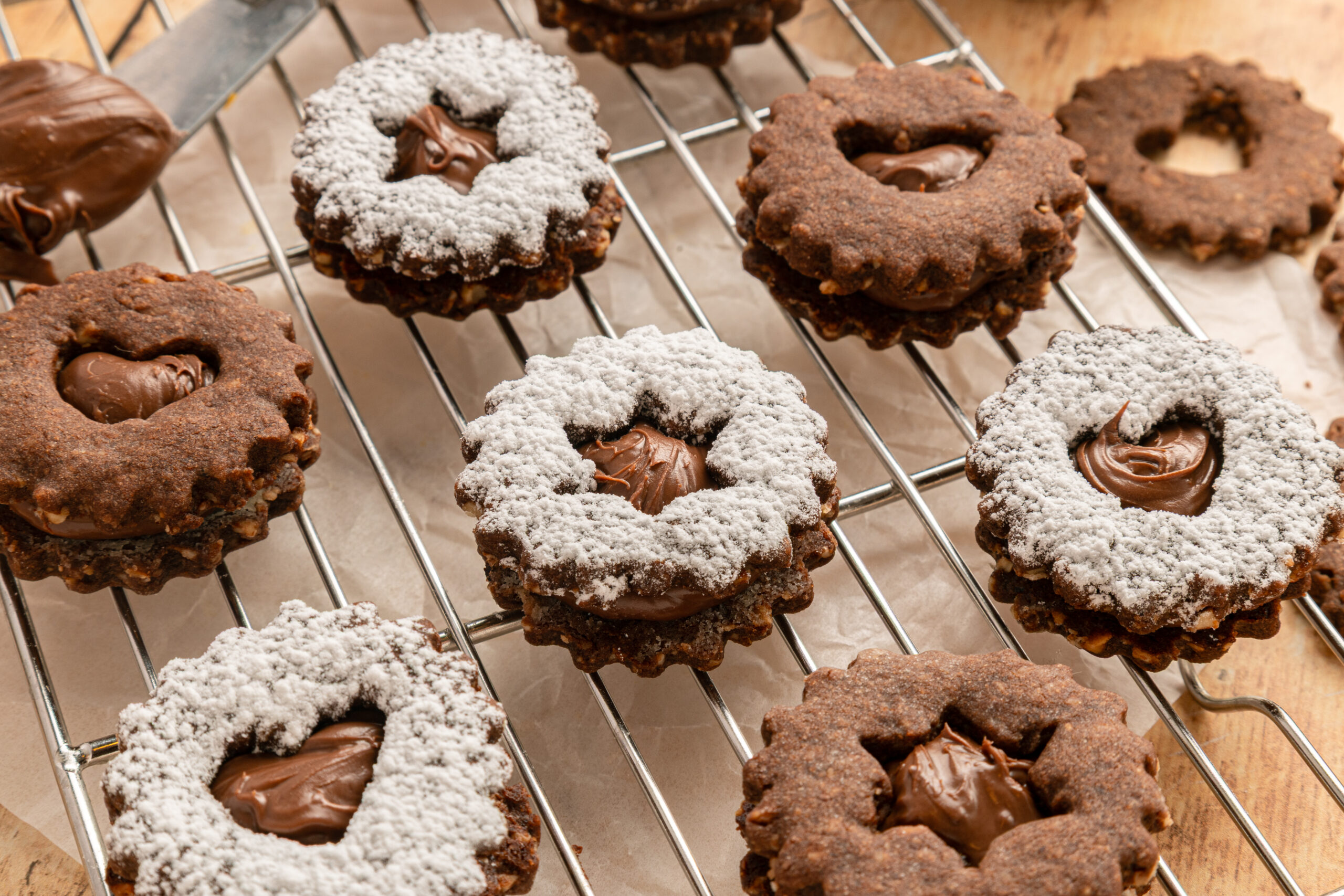 cooling rack full of Chocolate Linzer Cookies