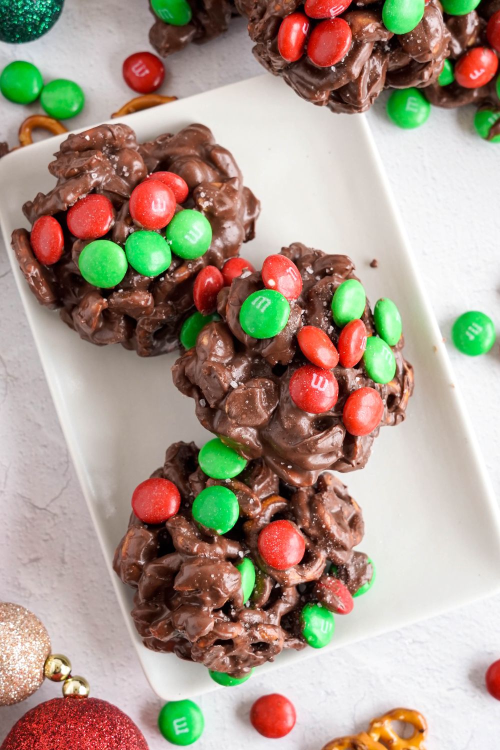 Crockpot Chocolate Pretzel Christmas Candy in a row on a white rectangle tray