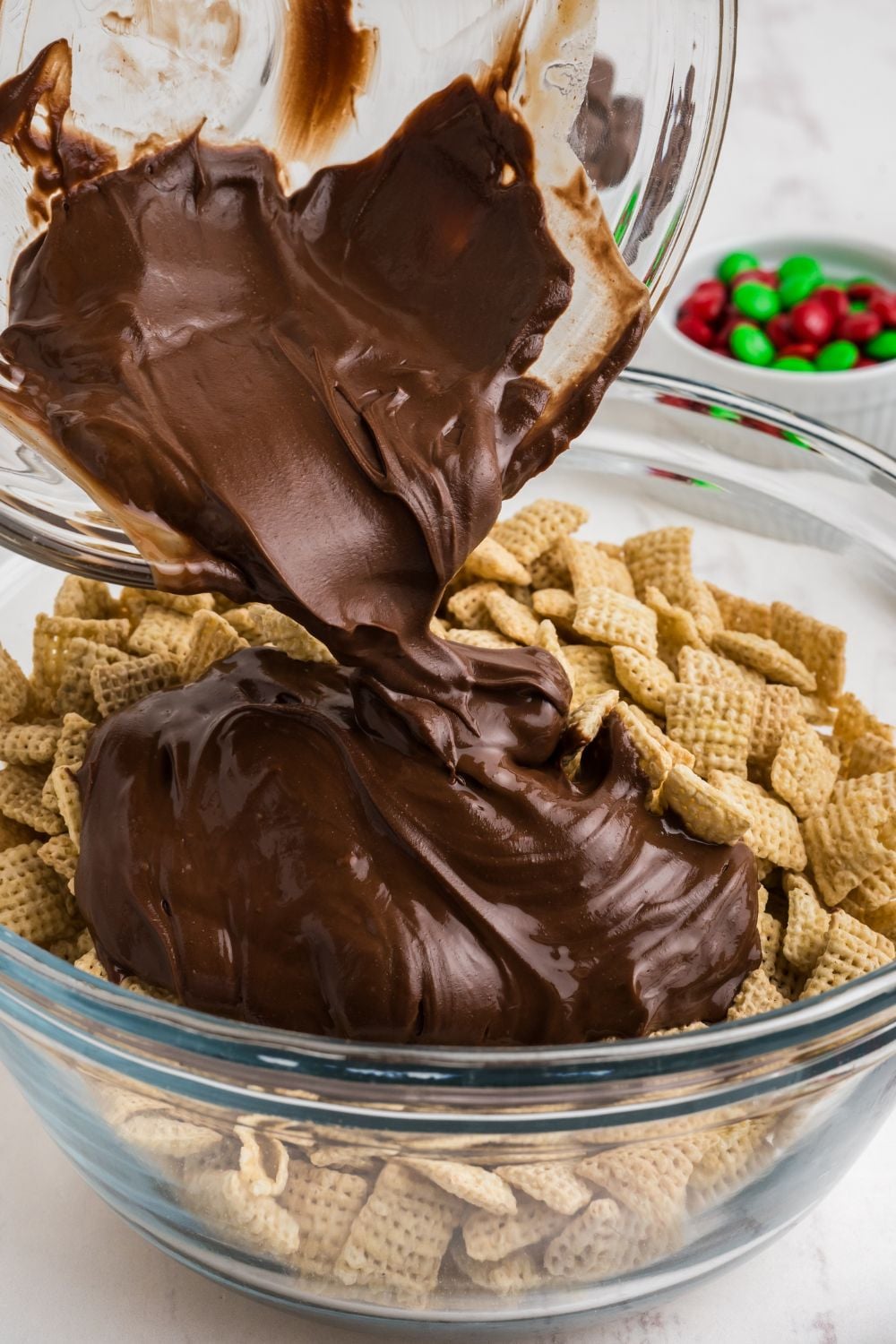 chocolate mixture pour in a bowl with chex cereal
