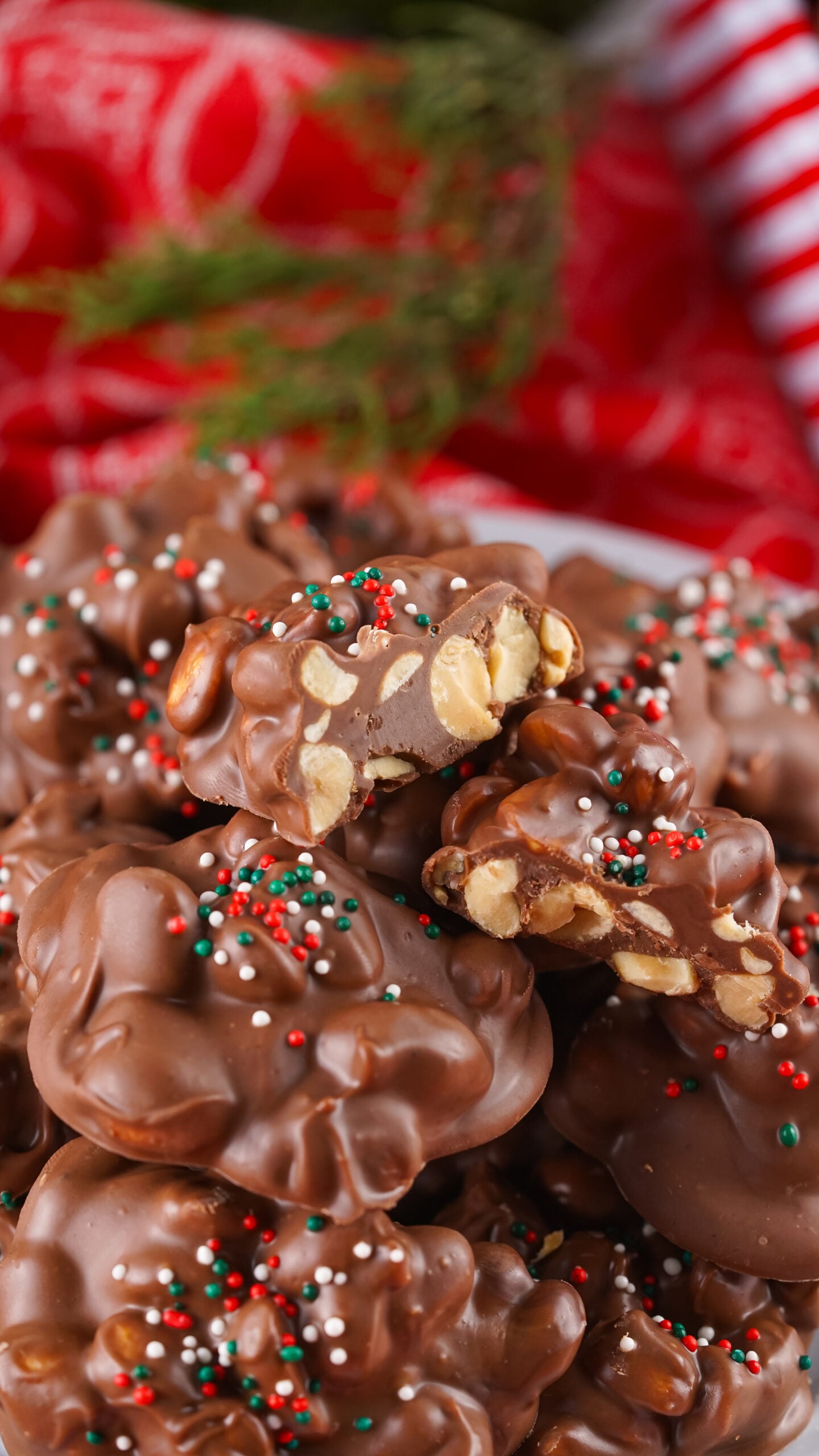 Crockpot Christmas Candy on a white plate with a bite missing from the top one