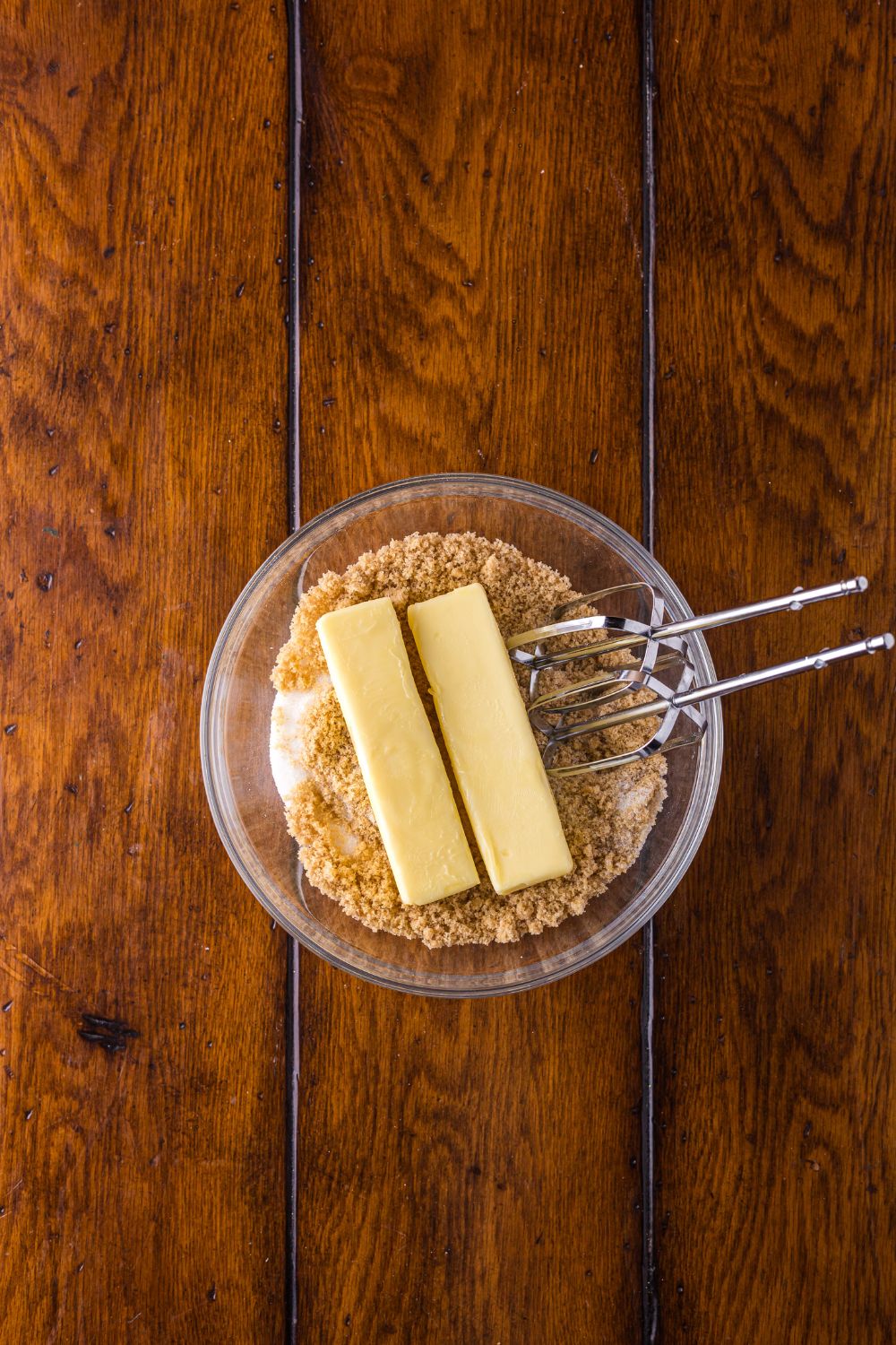 brown sugar and two sticks of butter with a glass bowl