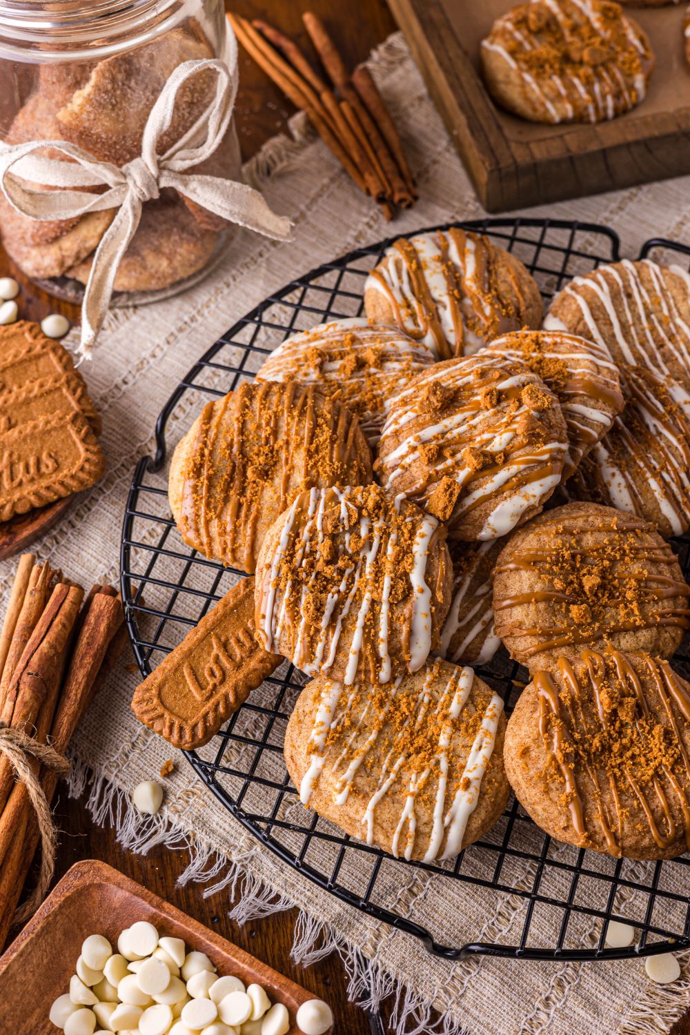 round cooling rack topped with Biscoff Snickerdoodle Cookies and a jar with ribbon and cookies