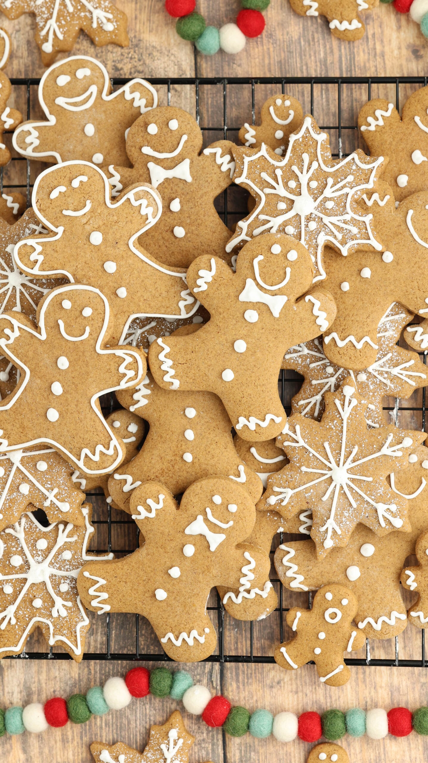 cooling rack with Christmas gingerbread cookies all over and different shapes 
