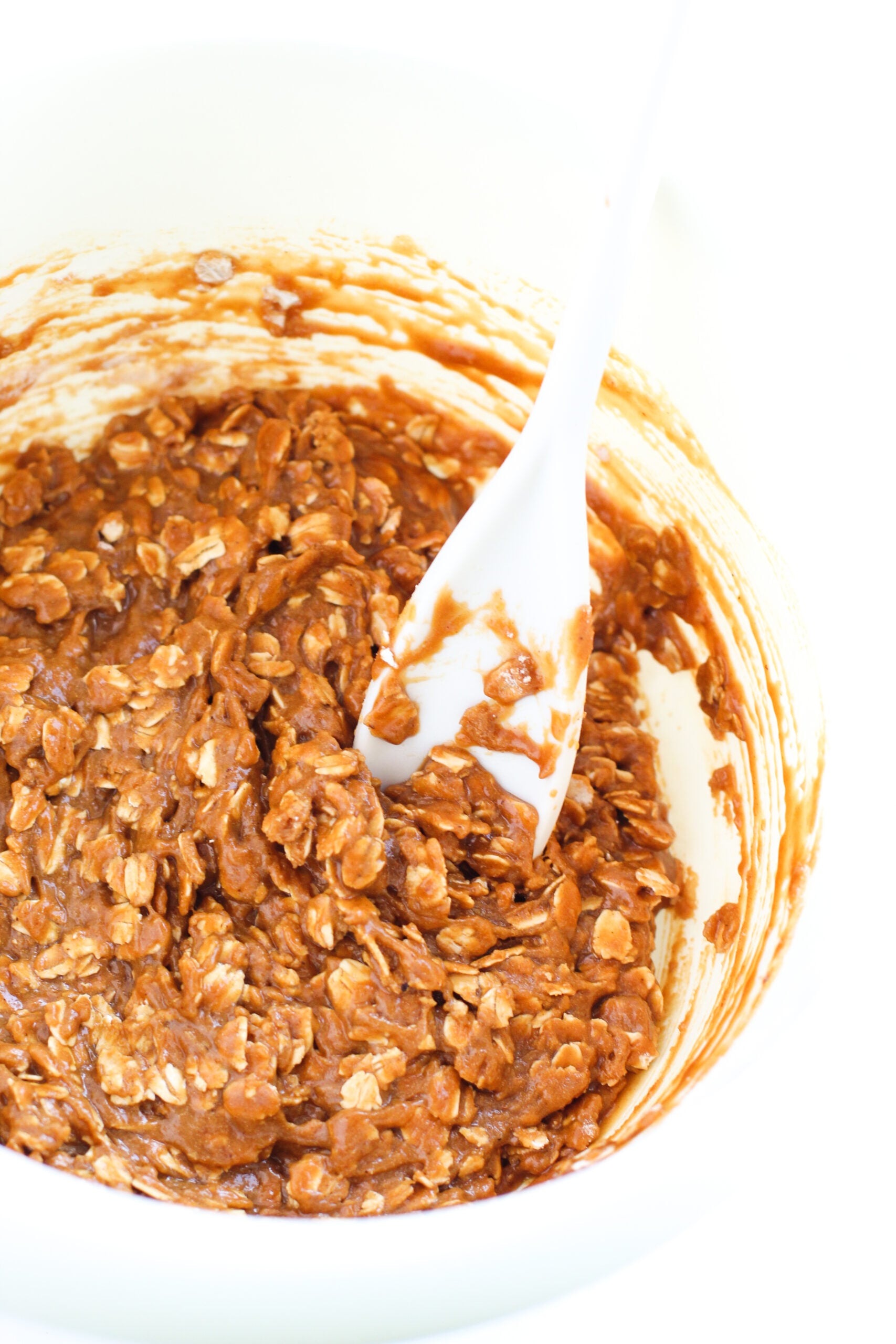 Bowl of Iced Gingerbread Oatmeal Cookie mix being mixed
