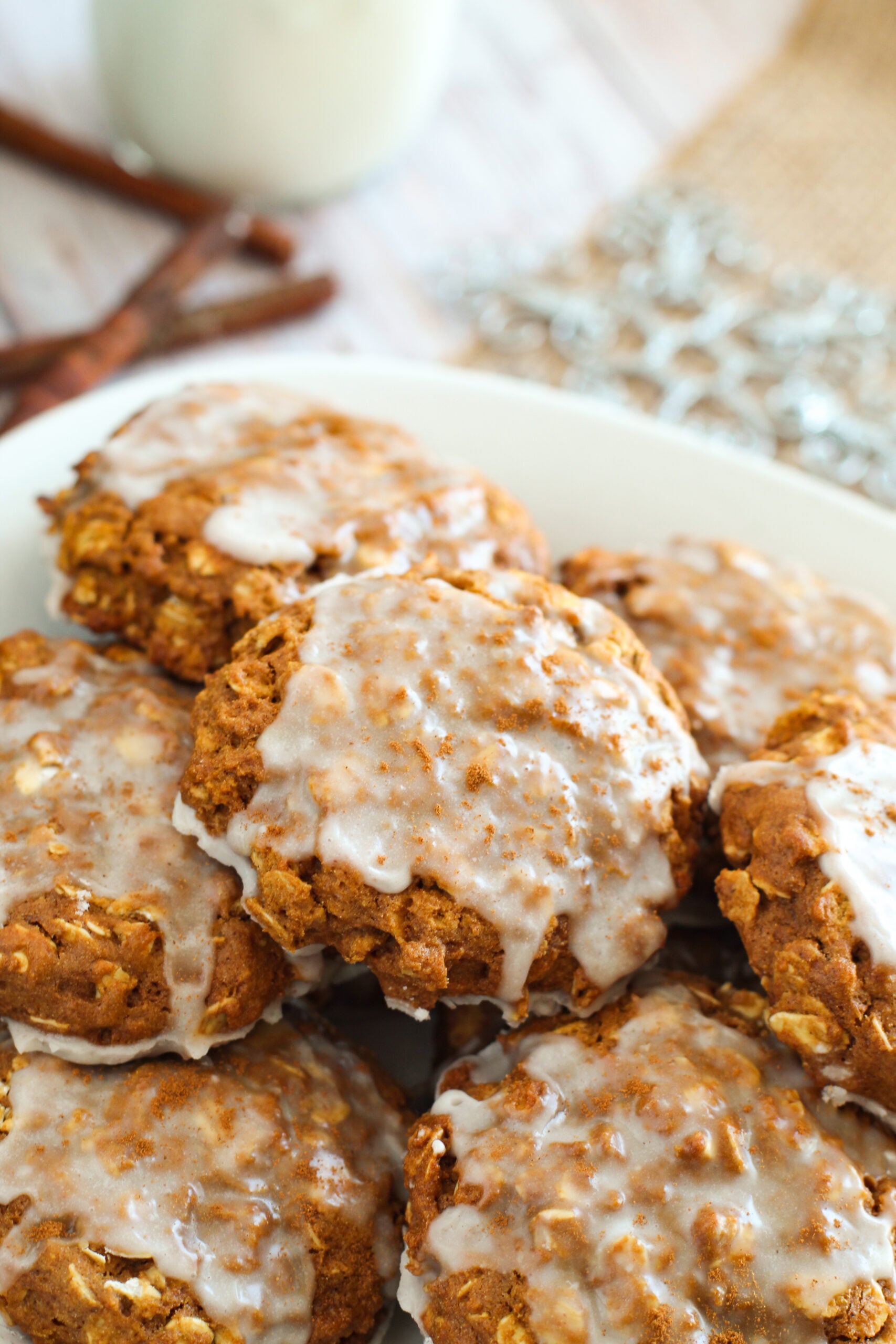 close up of a plate piled with Iced Gingerbread Oatmeal Cookies