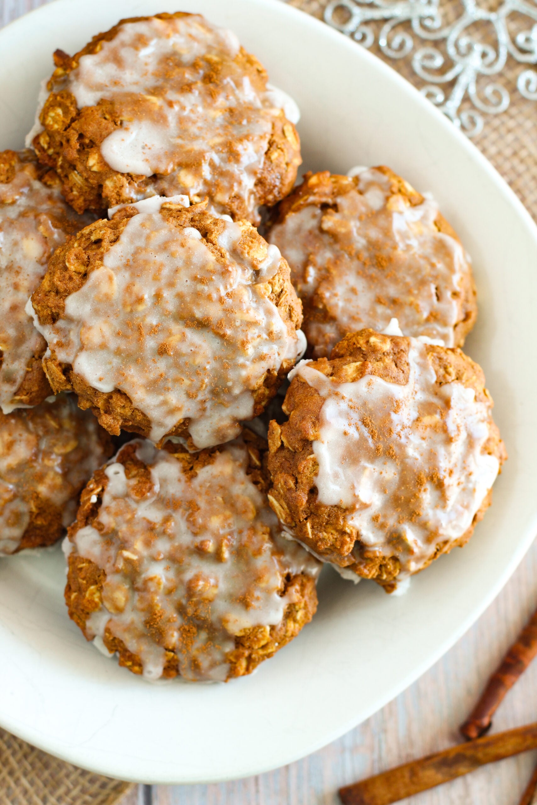 overhead shot of a plate filled with Iced Gingerbread Oatmeal Cookies