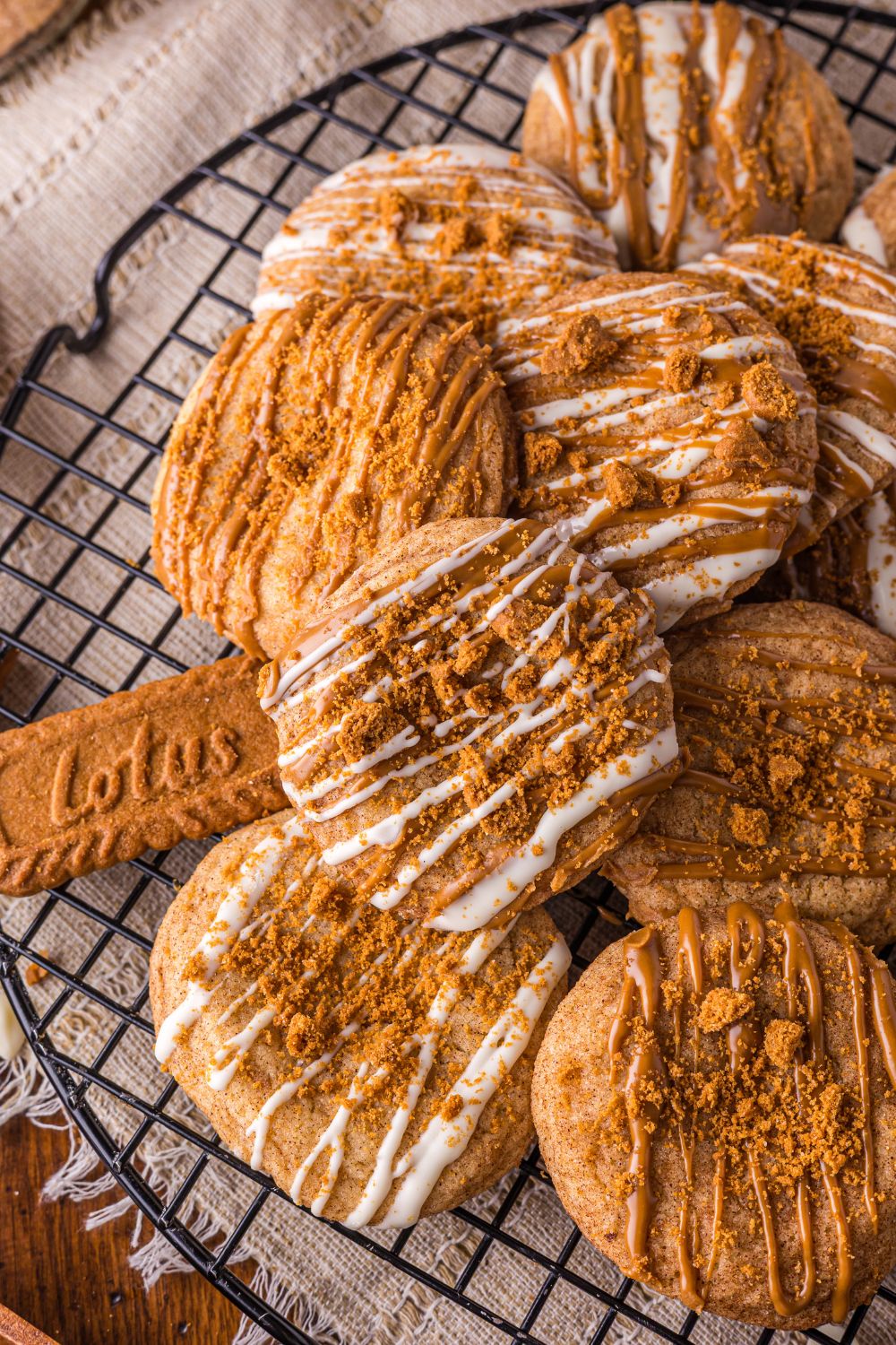 Biscoff Snickerdoodle Cookies on a cooling rack with Lotus cookies around the table