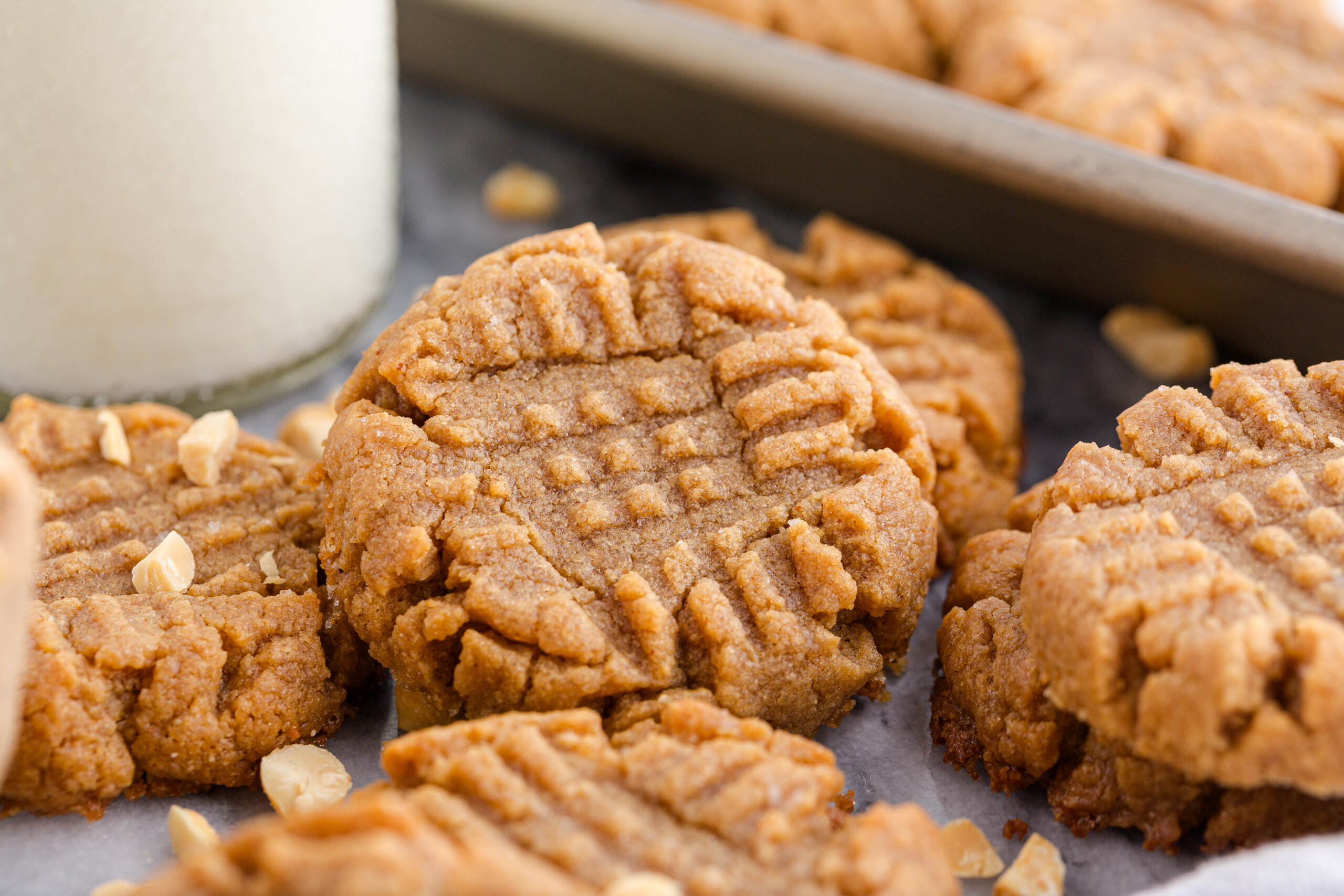 4 Ingredient Peanut Butter Cookies with a cup of milk in the background