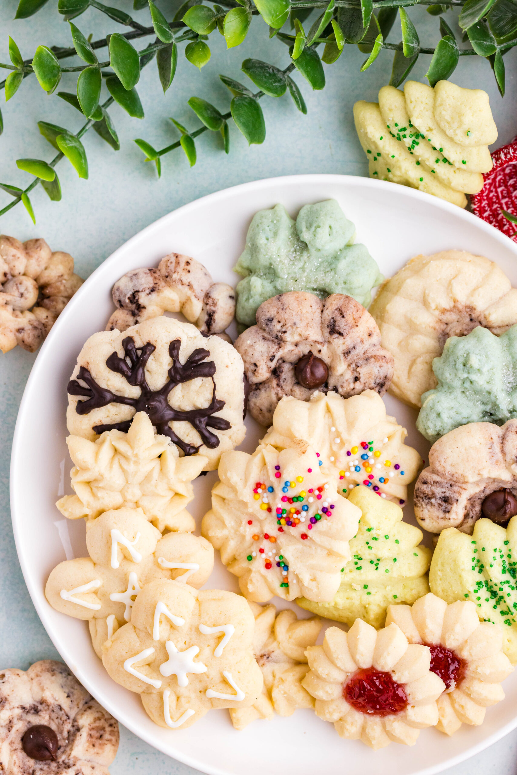 Overhead shot of a white plate filled with Spritz Christmas Cookies