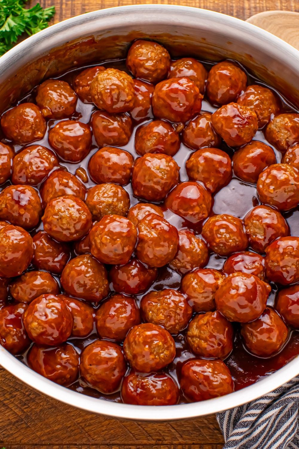 overhead look of a skillet on table with a skillet full of Peach BBQ Meatballs