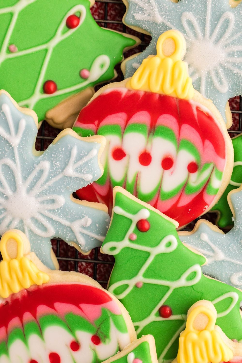 close up of Decorated Sugar Cookies in Christmas shapes sitting on a wooden table