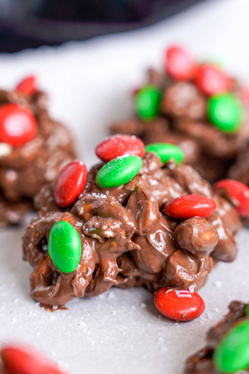 Crockpot Chocolate Pretzel Christmas Candy in piles on parchment paper